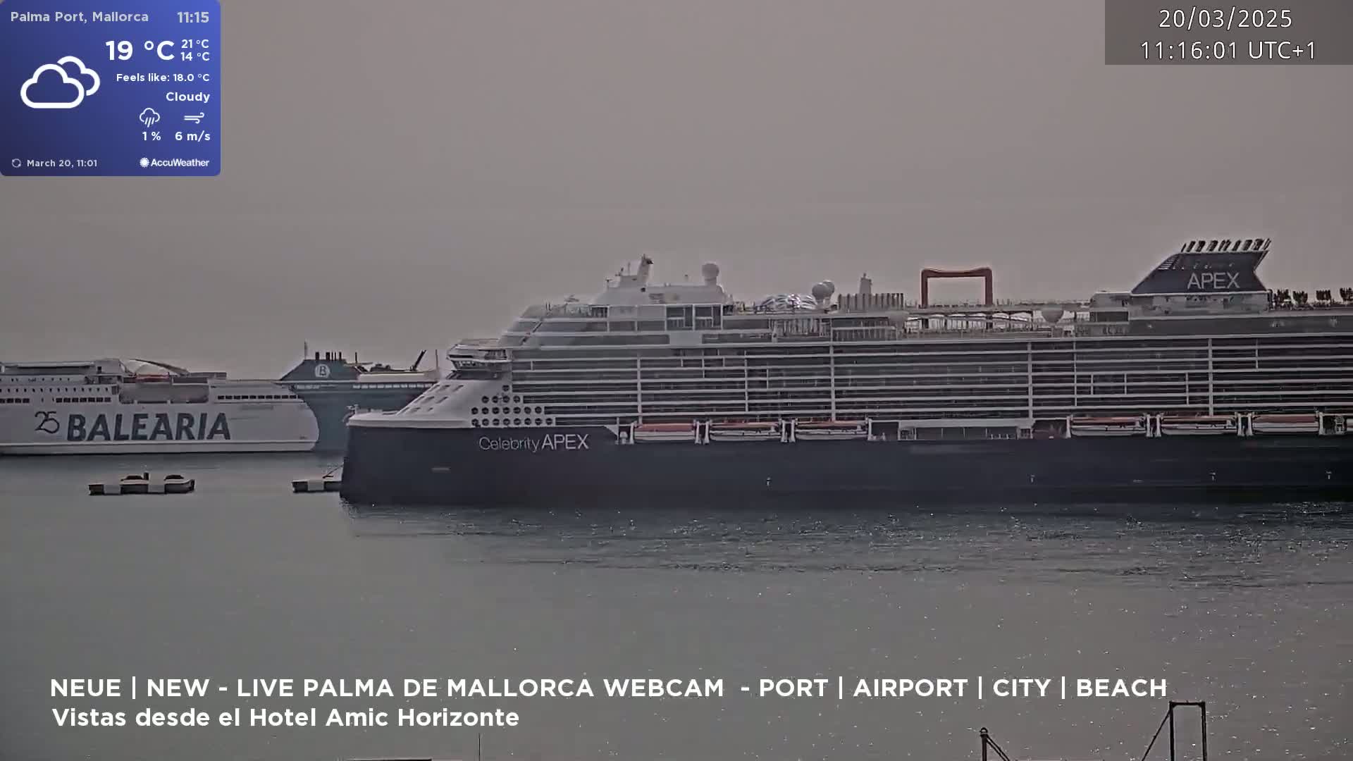 A large cruise ship and a ferry are docked in a harbor under cloudy skies.