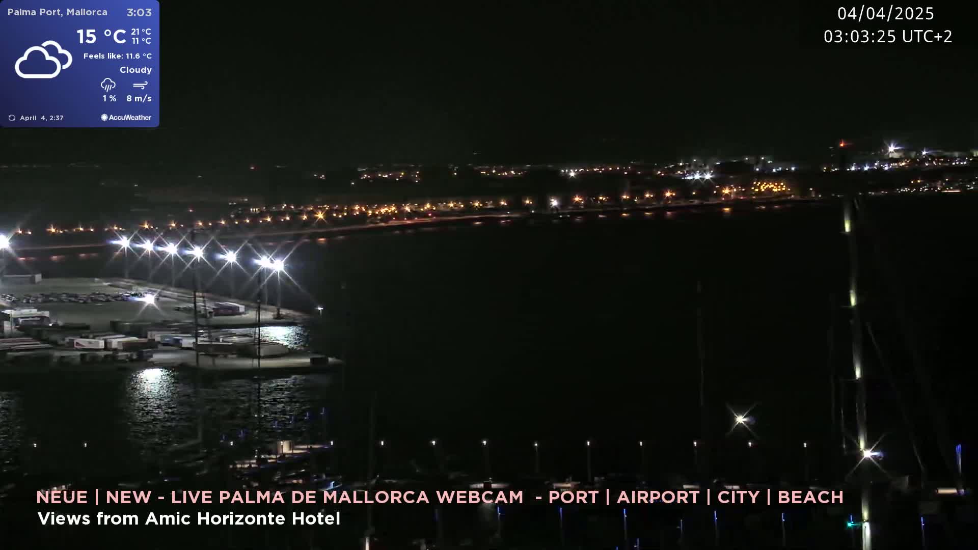 A nighttime, cloudy scene shows a harbor with brightly lit docks and a distant city skyline under the cover of darkness.