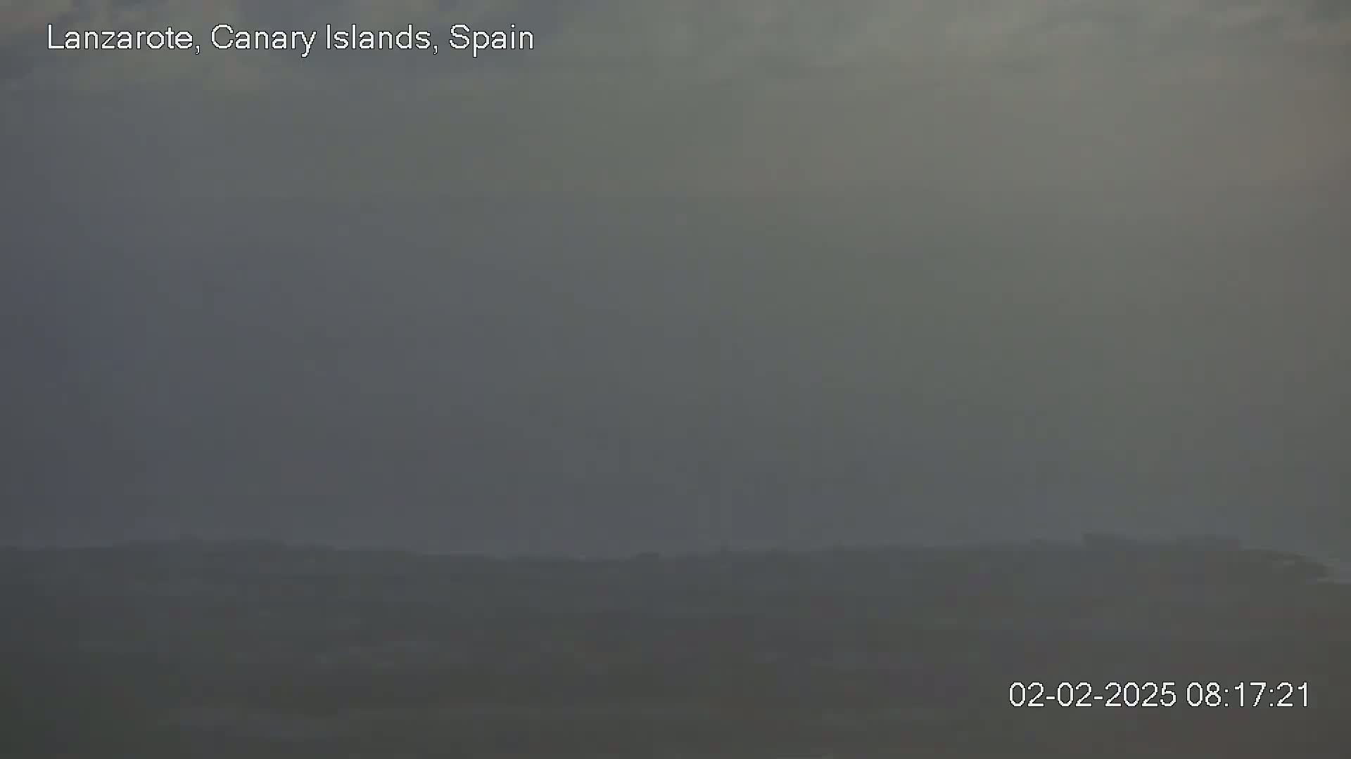 A hazy, indistinct landscape is visible under a muted sky.