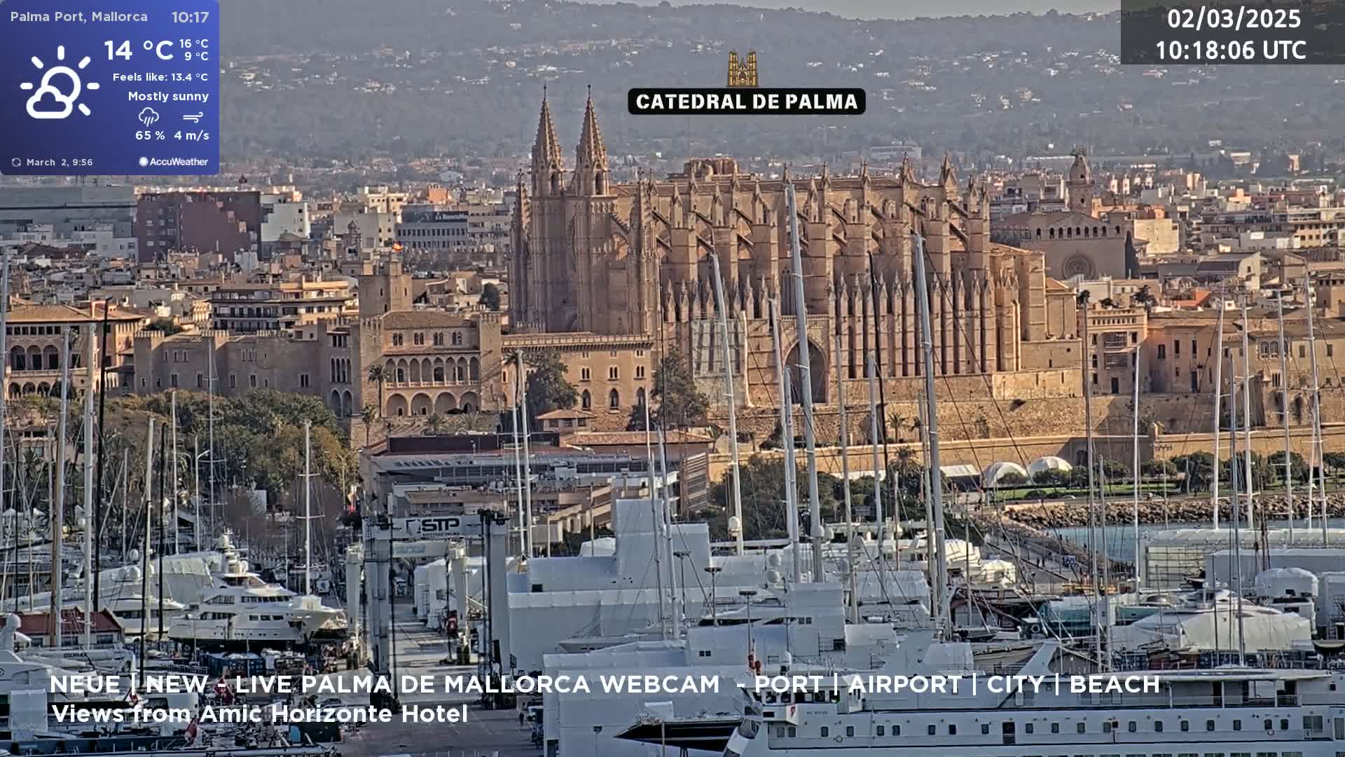 A mostly sunny cityscape with a large cathedral and a harbor filled with boats is visible under a mostly sunny sky.