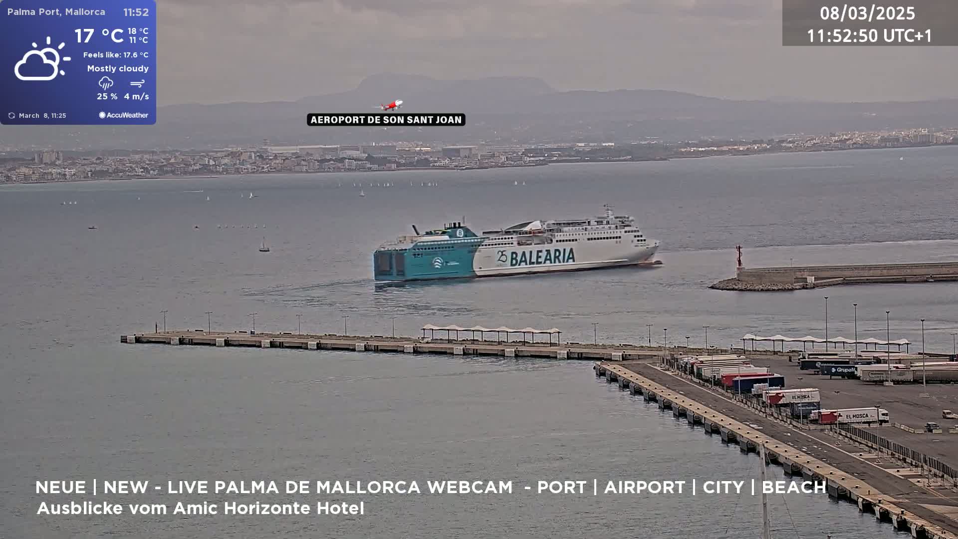 A large ferry approaches a port on a mostly cloudy day with a light breeze.