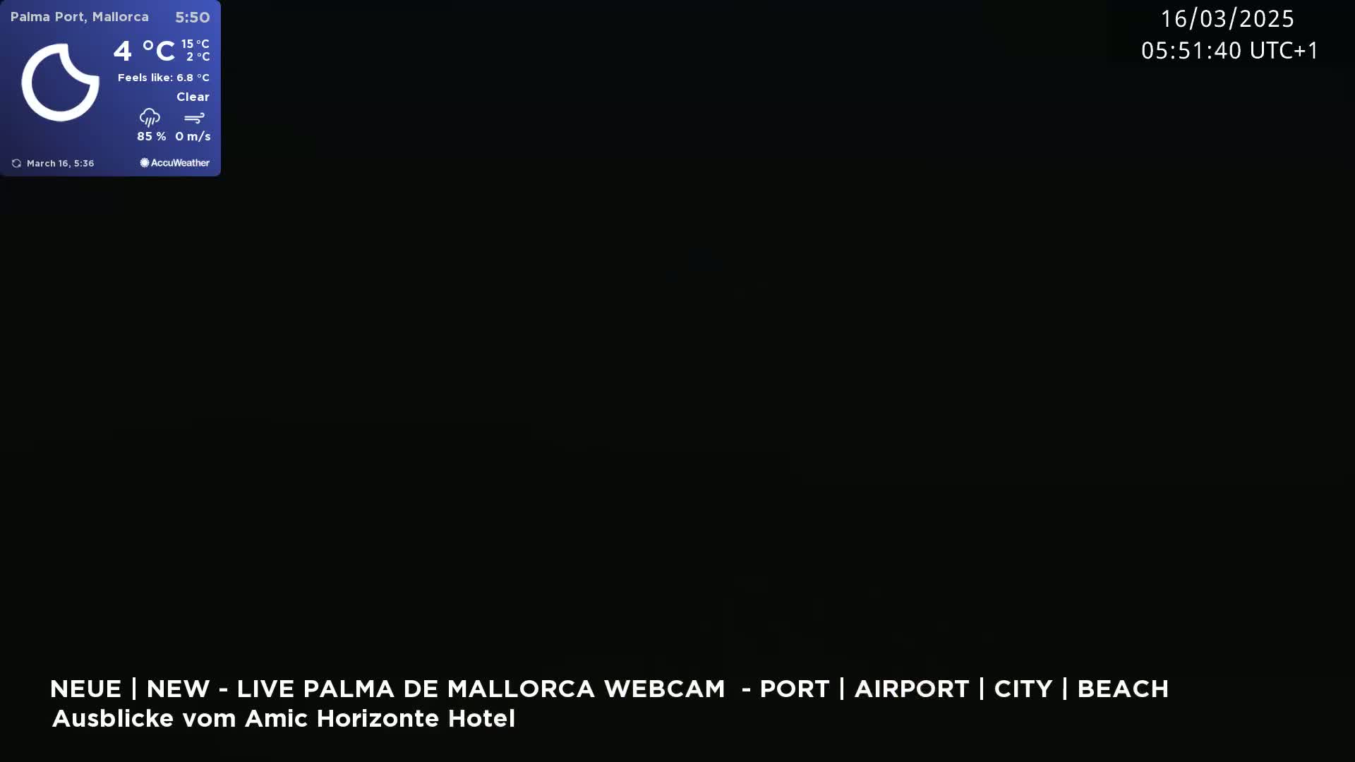 A nighttime webcam view shows a completely dark scene under clear skies.