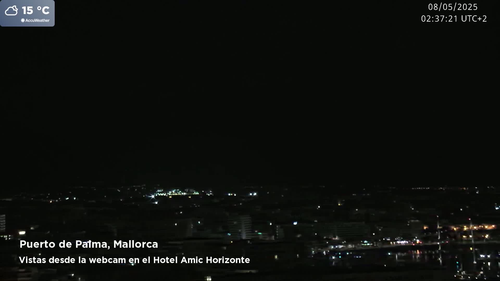 A nighttime view of a city illuminated by scattered lights under a clear, dark sky.
