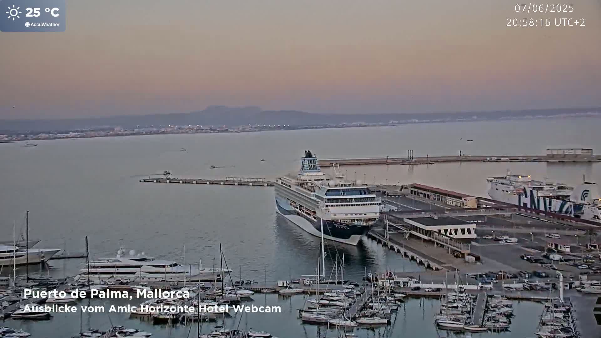 A cruise ship is docked at a harbor filled with many smaller boats, under a twilight sky with a temperature of 25°C.