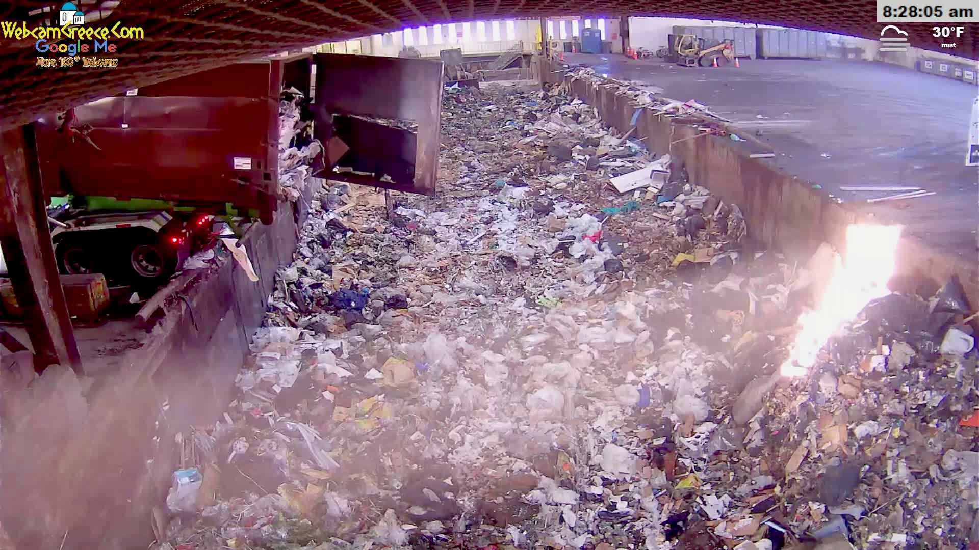 A large pile of trash is smoldering in a misty, 30°F outdoor environment, with a garbage truck partially visible in the background.