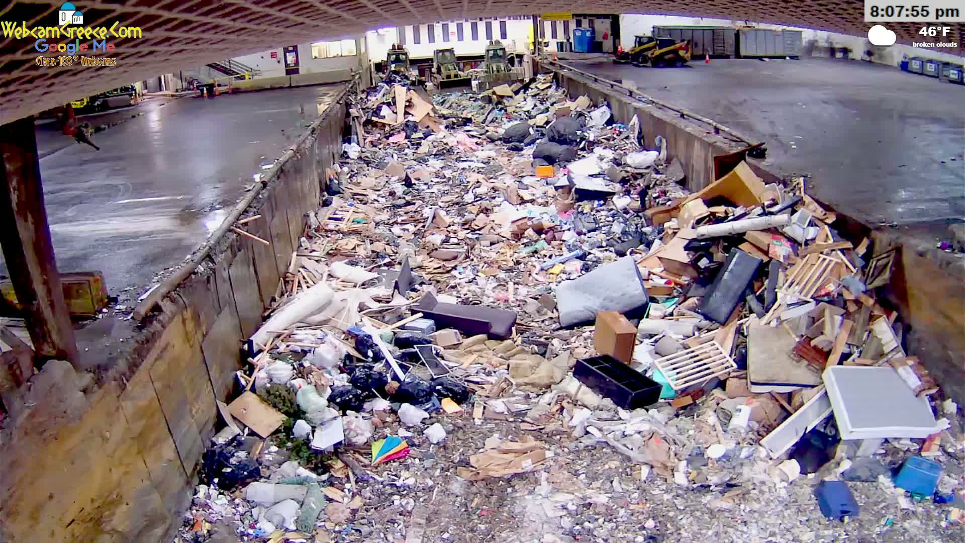 A large pile of refuse sits in an outdoor loading dock under broken clouds at 46°F.
