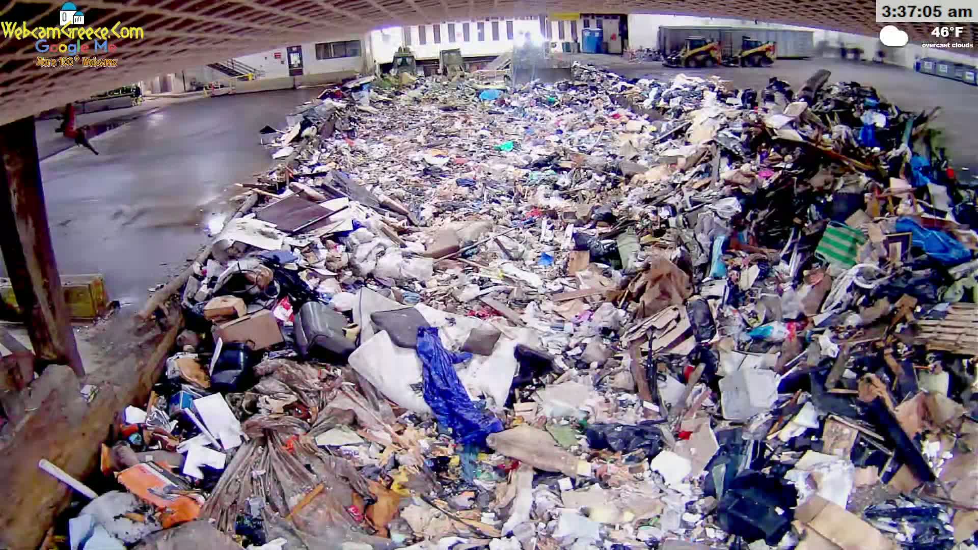 A large pile of trash sits in an outdoor area under overcast skies at 46°F.