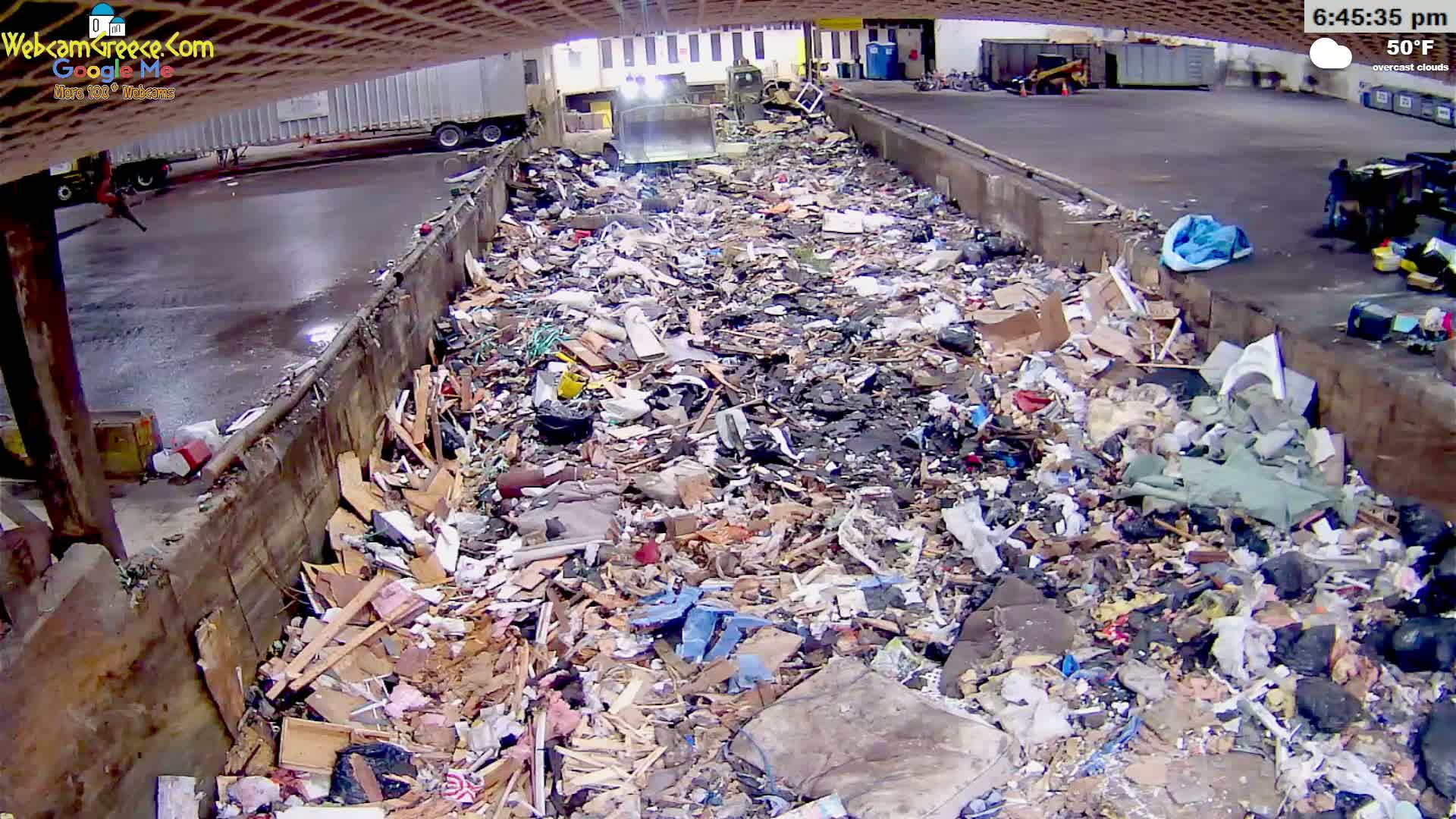 A large pile of refuse sits in an outdoor, overcast area at 50°F.