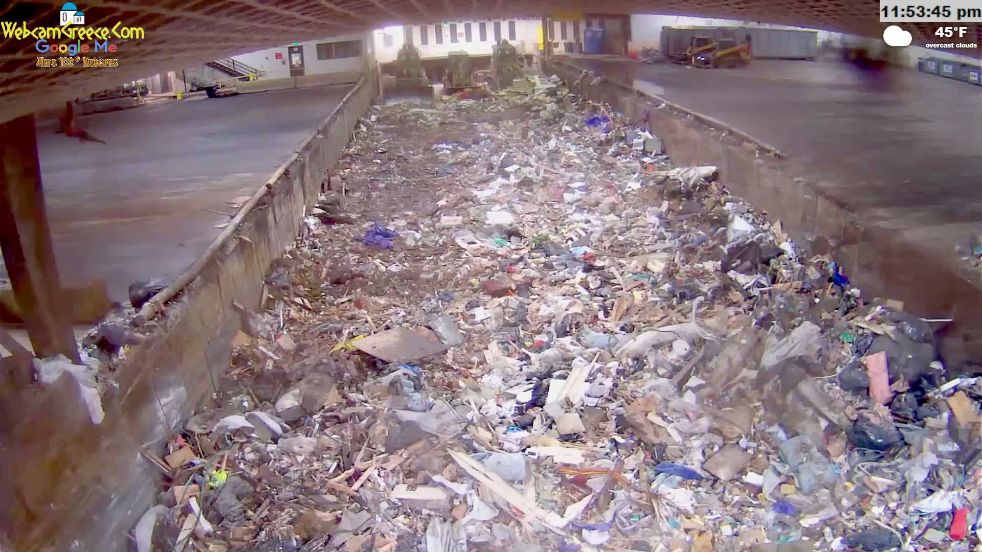 A large pile of garbage sits in an outdoor, overcast area at 45°F.