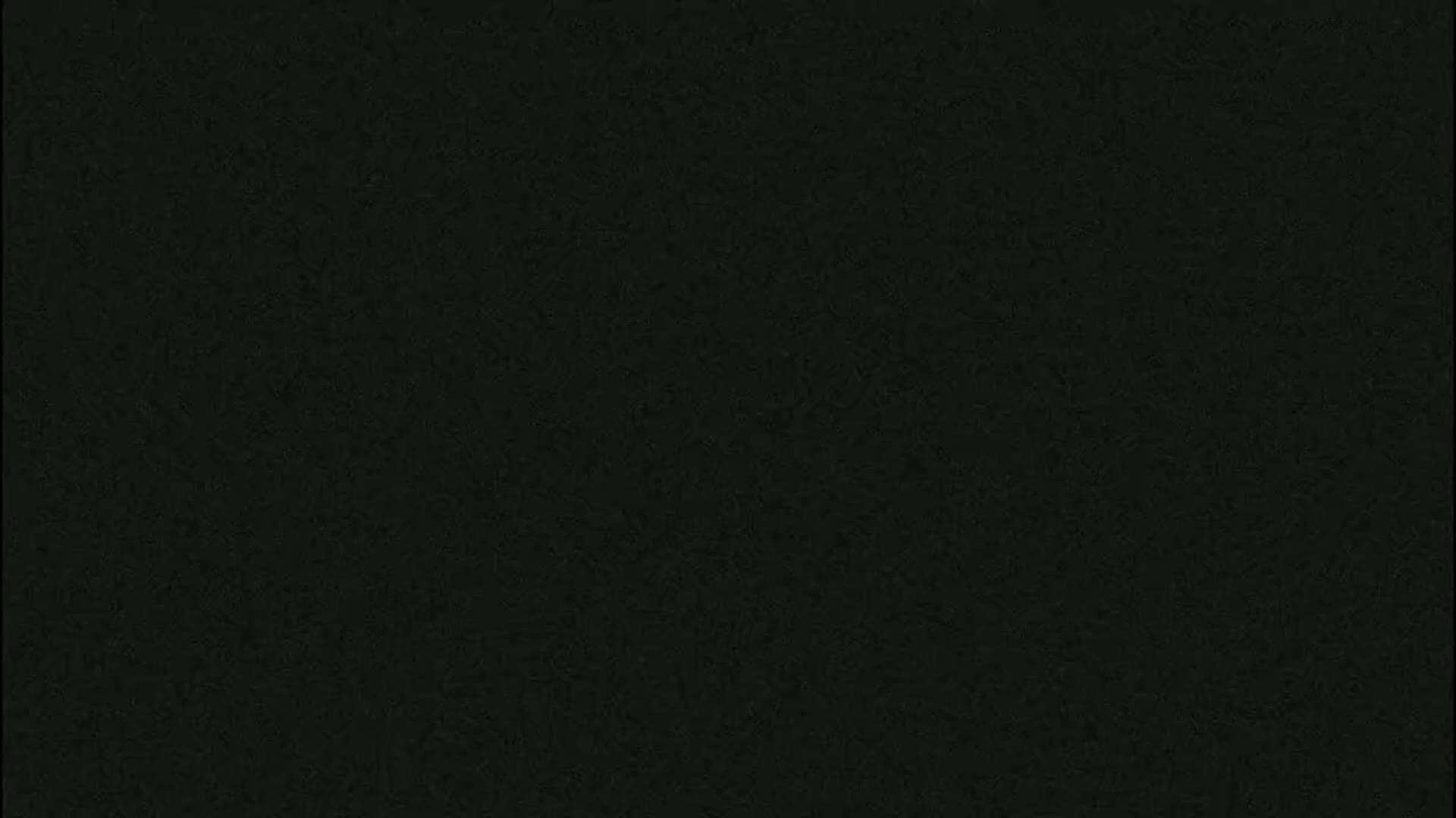 The image is a solid, dark-gray or black textured background.