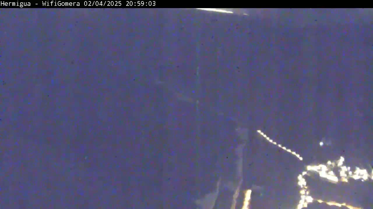 A nighttime, low-light view shows a blurry image of possibly a city or town lights in the distance.