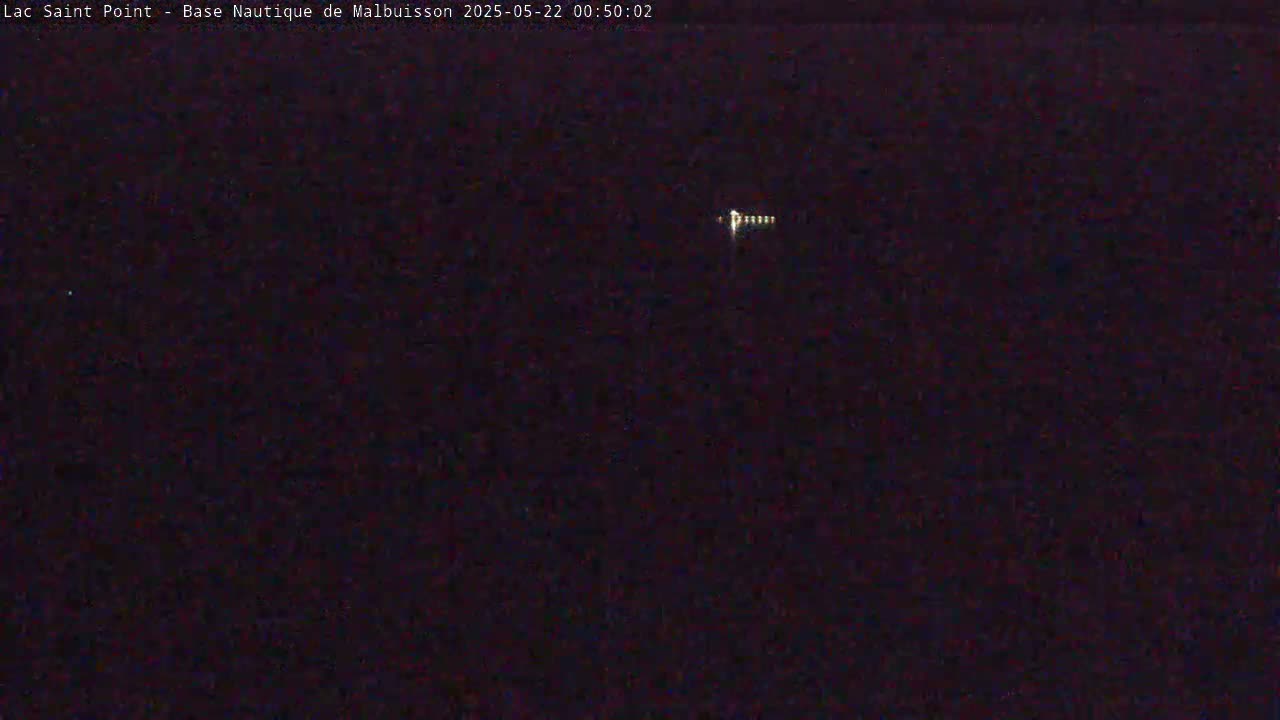 A small cluster of lights is visible in the dark night sky.