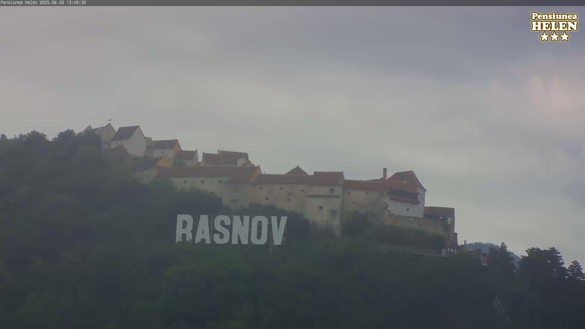 A hilltop castle is visible under an overcast sky, with the name "RASNOV" displayed prominently in large letters below it.