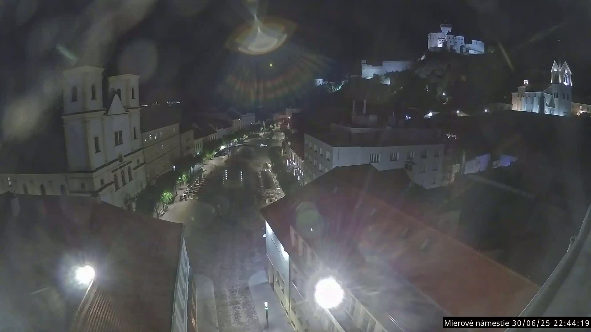 Trenčín, Piaristický kostol sv. Františka Xaverského Church & Trenciansky Hrad (Ttencin Castle) at Mierové námestie Square East View Live Cam - Trencin, Okres Trencin, Slovakia 