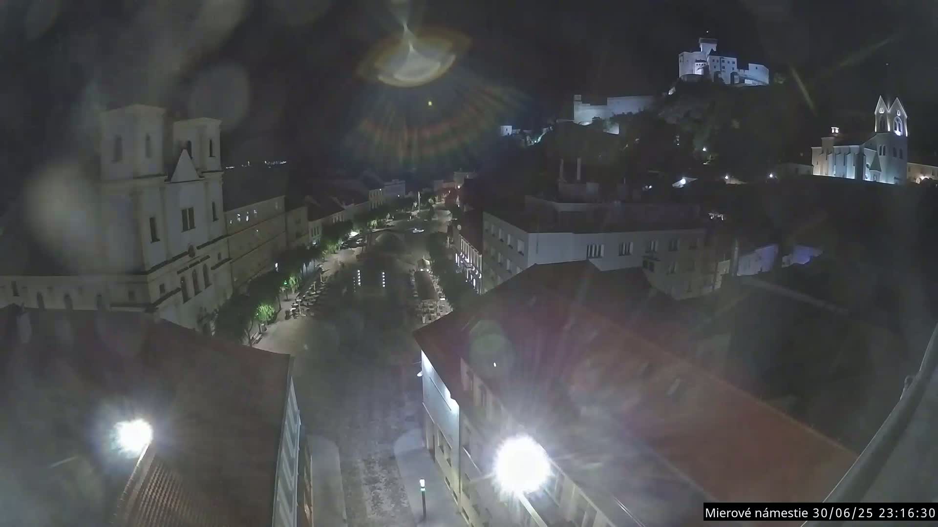 Trenčín, Piaristický kostol sv. Františka Xaverského Church & Trenciansky Hrad (Ttencin Castle) at Mierové námestie Square East View Live Cam - Trencin, Okres Trencin, Slovakia 