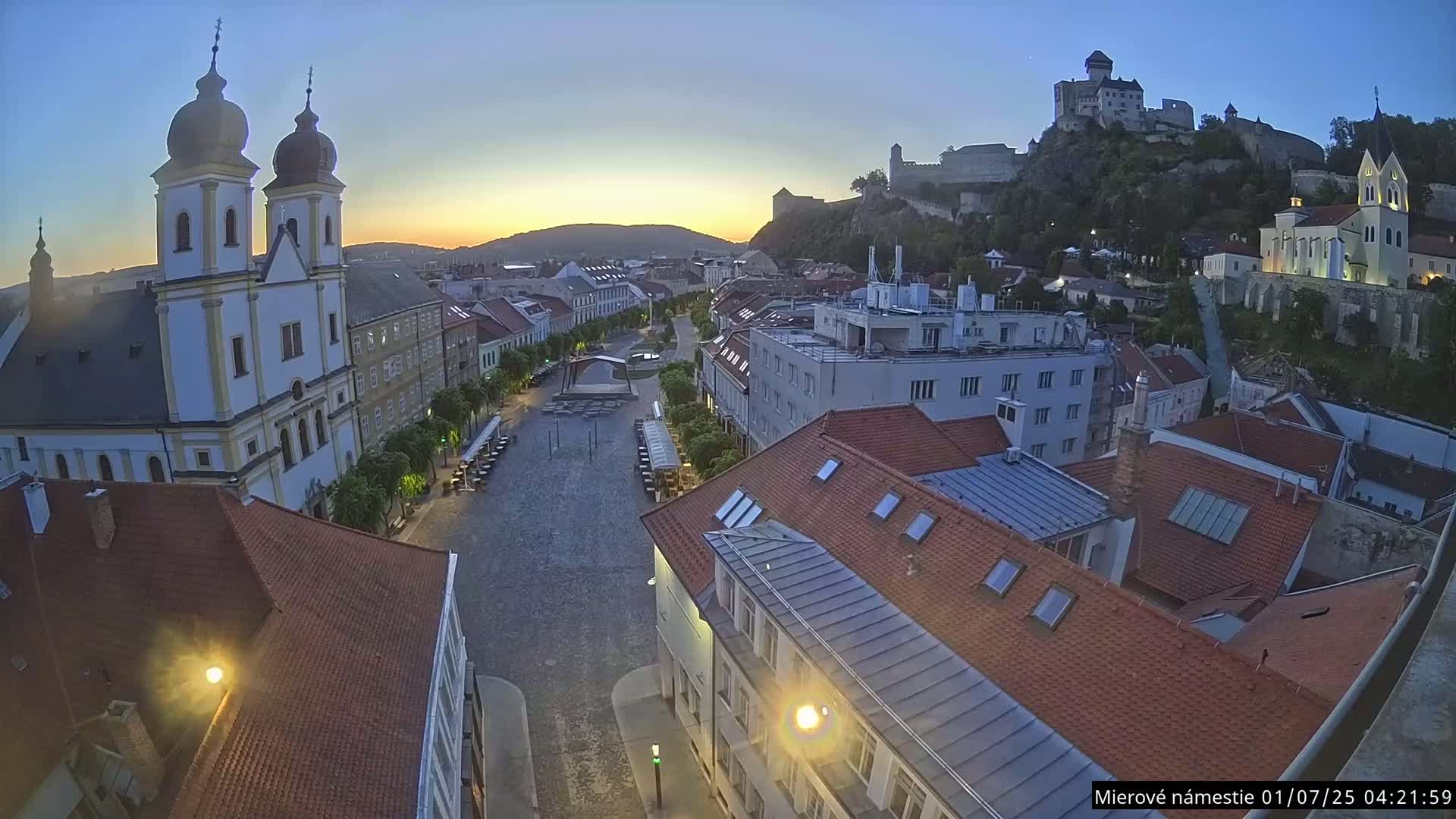 Trenčín, Piaristický kostol sv. Františka Xaverského Church & Trenciansky Hrad (Ttencin Castle) at Mierové námestie Square East View Live Cam - Trencin, Okres Trencin, Slovakia 