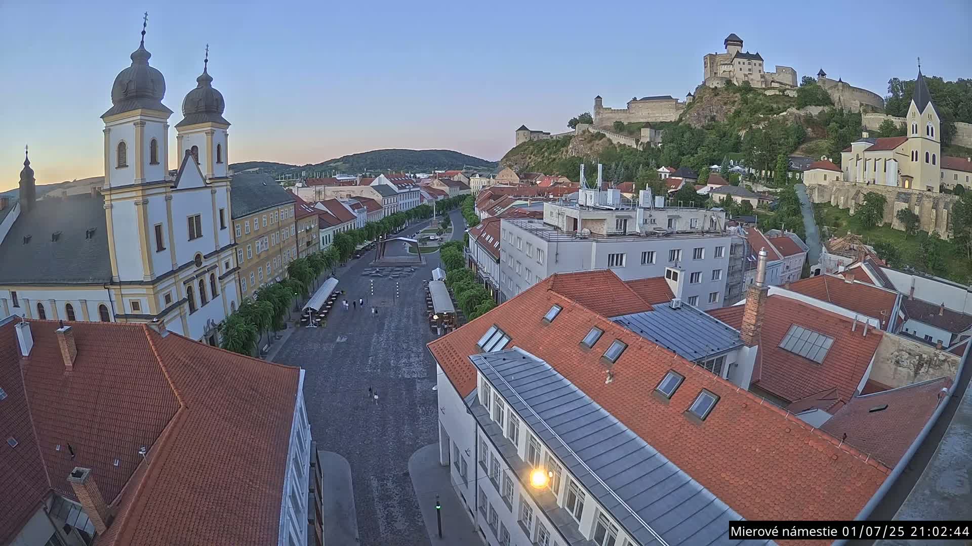 Trenčín, Piaristický kostol sv. Františka Xaverského Church & Trenciansky Hrad (Ttencin Castle) at Mierové námestie Square East View Live Cam - Trencin, Okres Trencin, Slovakia 
