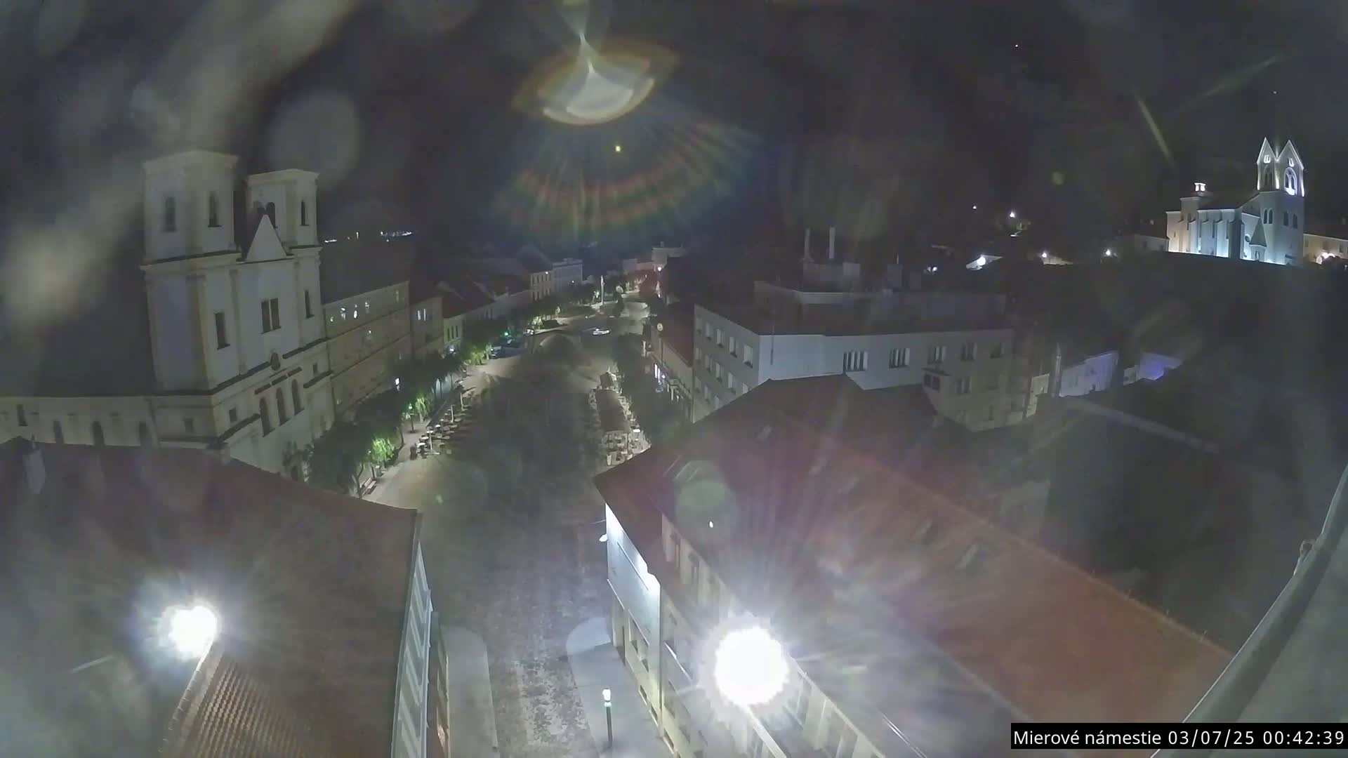 Trenčín, Piaristický kostol sv. Františka Xaverského Church & Trenciansky Hrad (Ttencin Castle) at Mierové námestie Square East View Live Cam - Trencin, Okres Trencin, Slovakia 