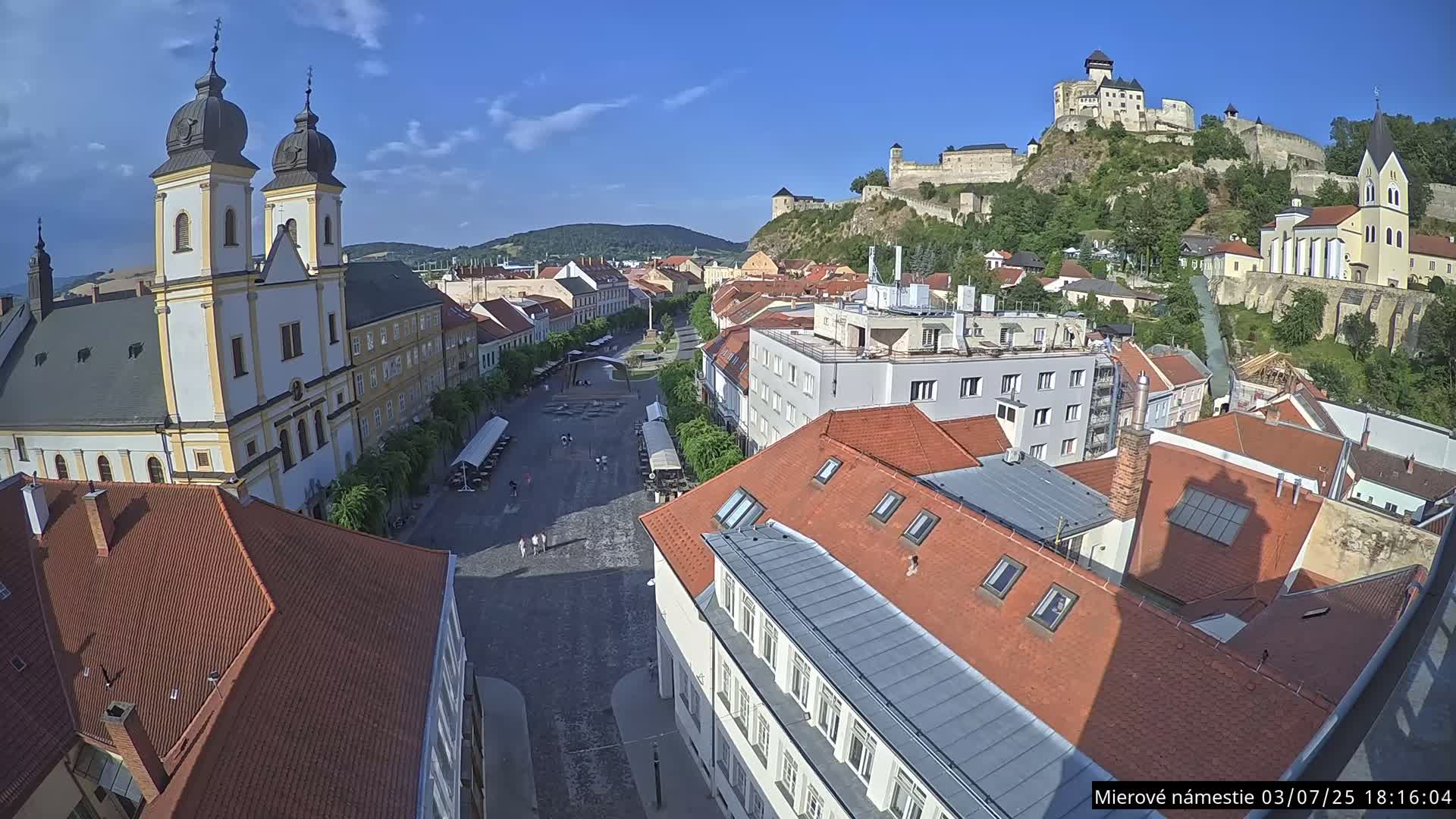 Trenčín, Piaristický kostol sv. Františka Xaverského Church & Trenciansky Hrad (Ttencin Castle) at Mierové námestie Square East View Live Cam - Trencin, Okres Trencin, Slovakia 