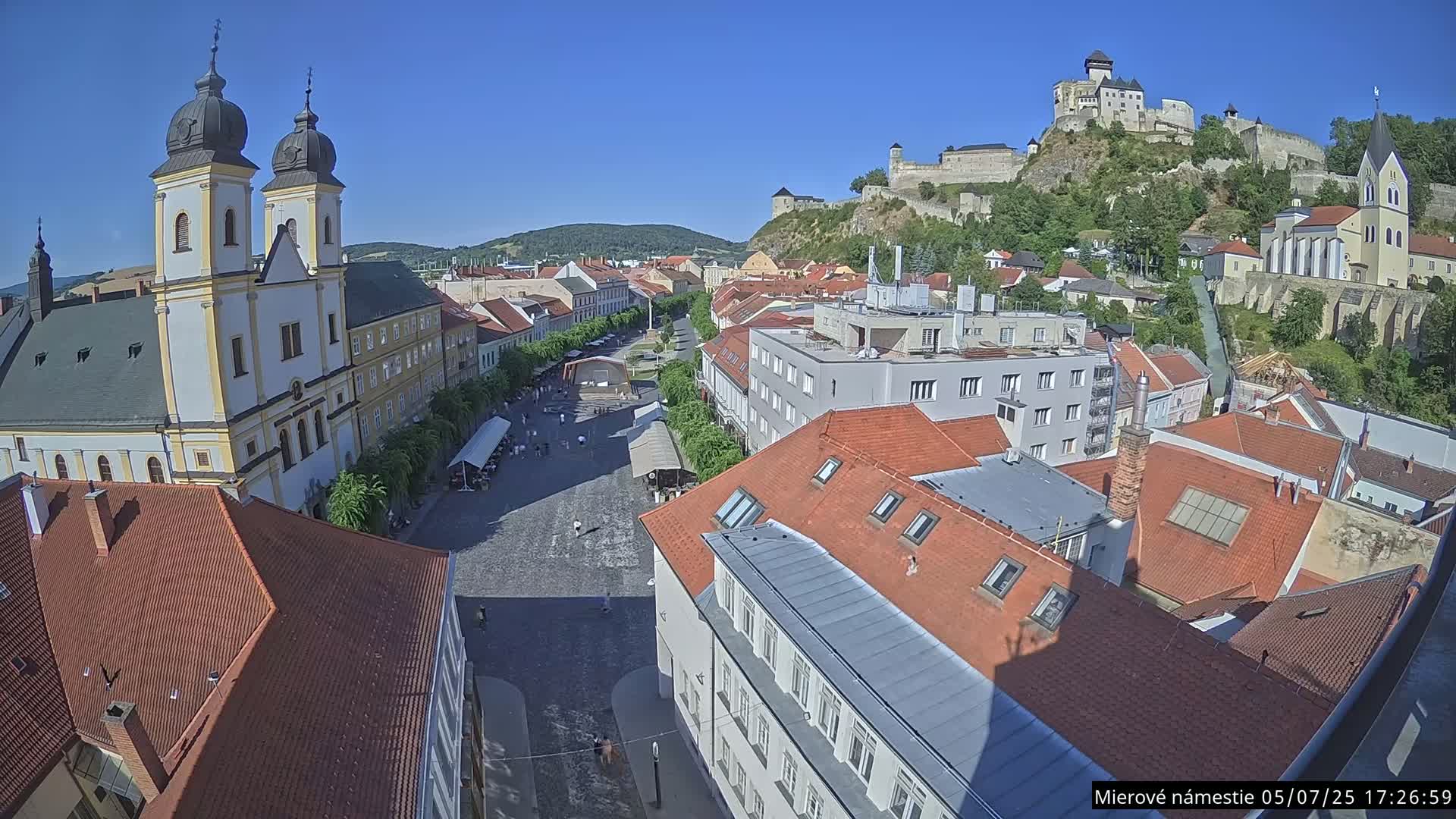 Trenčín, Piaristický kostol sv. Františka Xaverského Church & Trenciansky Hrad (Ttencin Castle) at Mierové námestie Square East View Live Cam - Trencin, Okres Trencin, Slovakia 