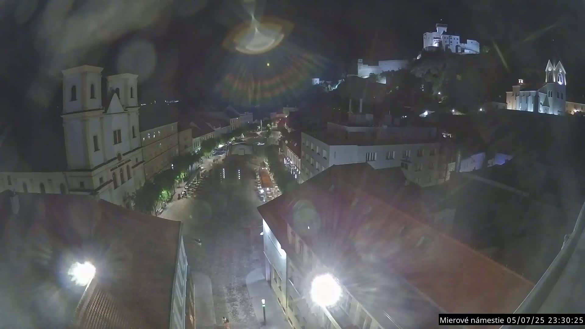 Trenčín, Piaristický kostol sv. Františka Xaverského Church & Trenciansky Hrad (Ttencin Castle) at Mierové námestie Square East View Live Cam - Trencin, Okres Trencin, Slovakia 