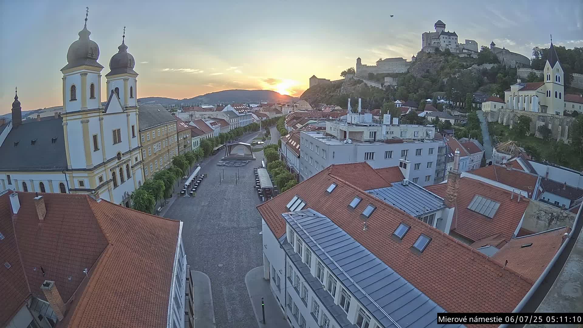 Trenčín, Piaristický kostol sv. Františka Xaverského Church & Trenciansky Hrad (Ttencin Castle) at Mierové námestie Square East View Live Cam - Trencin, Okres Trencin, Slovakia 