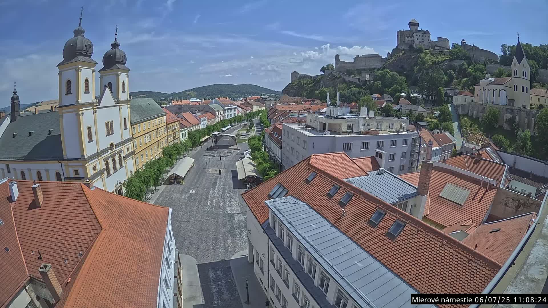 Trenčín, Piaristický kostol sv. Františka Xaverského Church & Trenciansky Hrad (Ttencin Castle) at Mierové námestie Square East View Live Cam - Trencin, Okres Trencin, Slovakia 