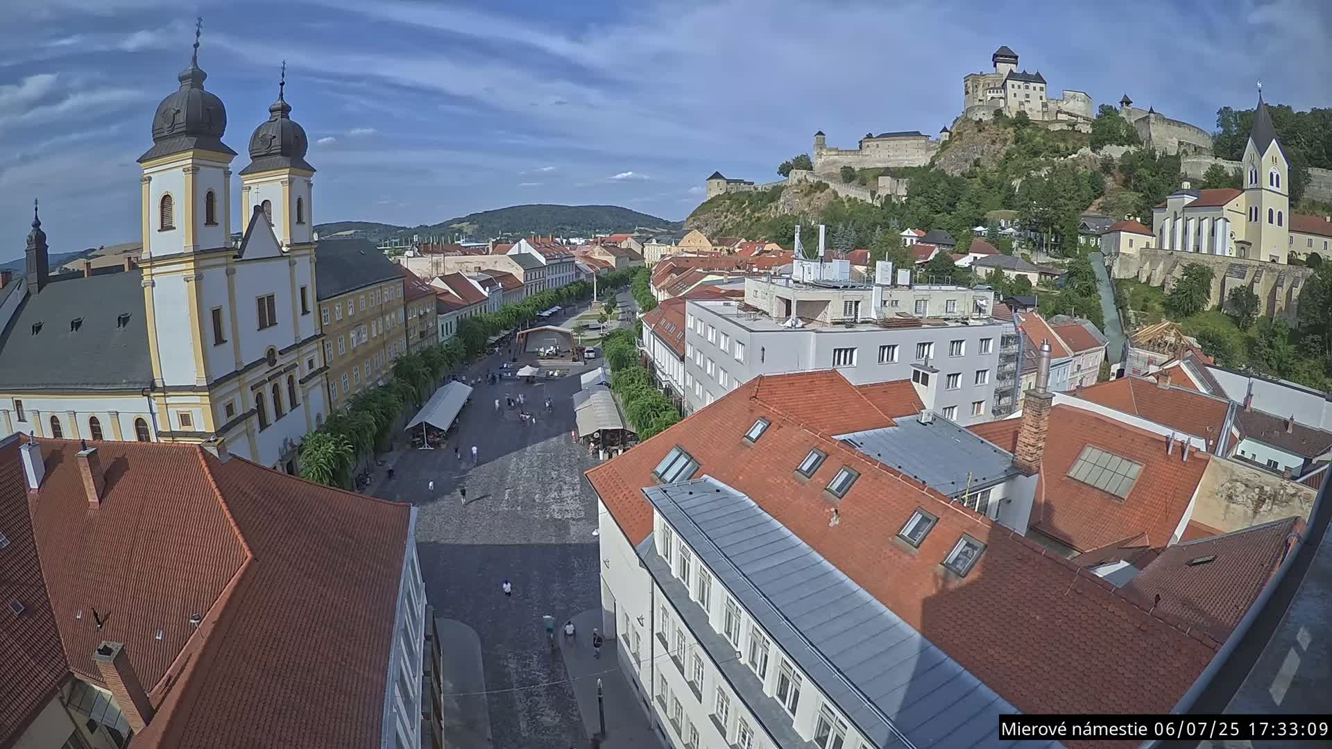 Trenčín, Piaristický kostol sv. Františka Xaverského Church & Trenciansky Hrad (Ttencin Castle) at Mierové námestie Square East View Live Cam - Trencin, Okres Trencin, Slovakia 