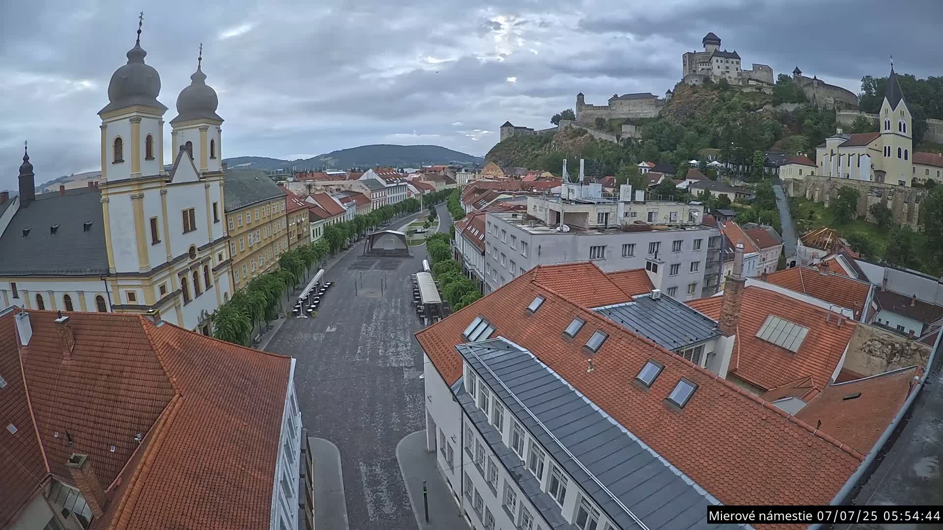 Trenčín, Piaristický kostol sv. Františka Xaverského Church & Trenciansky Hrad (Ttencin Castle) at Mierové námestie Square East View Live Cam - Trencin, Okres Trencin, Slovakia 