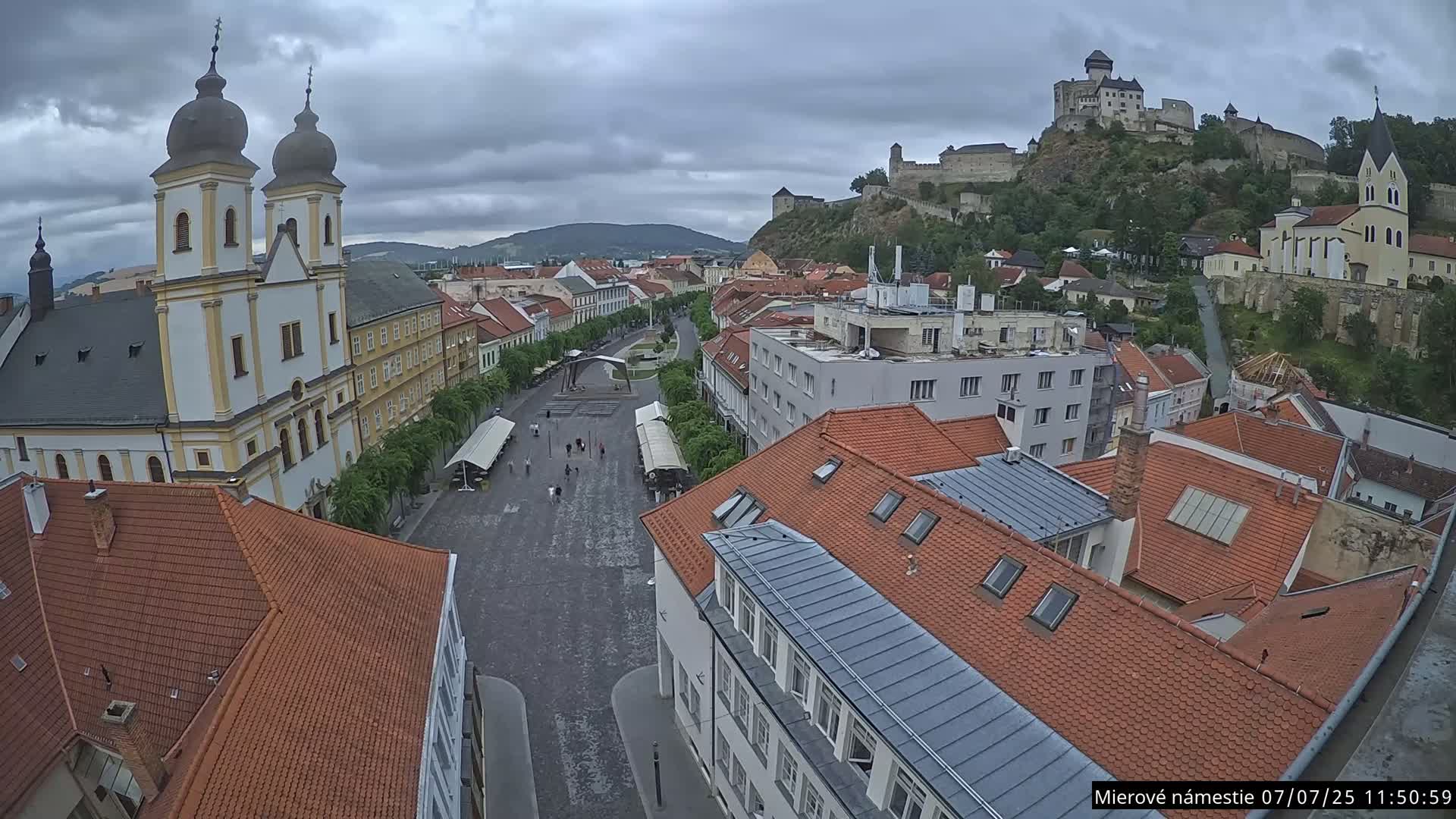 Trenčín, Piaristický kostol sv. Františka Xaverského Church & Trenciansky Hrad (Ttencin Castle) at Mierové námestie Square East View Live Cam - Trencin, Okres Trencin, Slovakia 