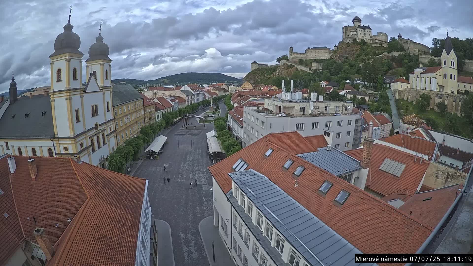 Trenčín, Piaristický kostol sv. Františka Xaverského Church & Trenciansky Hrad (Ttencin Castle) at Mierové námestie Square East View Live Cam - Trencin, Okres Trencin, Slovakia 