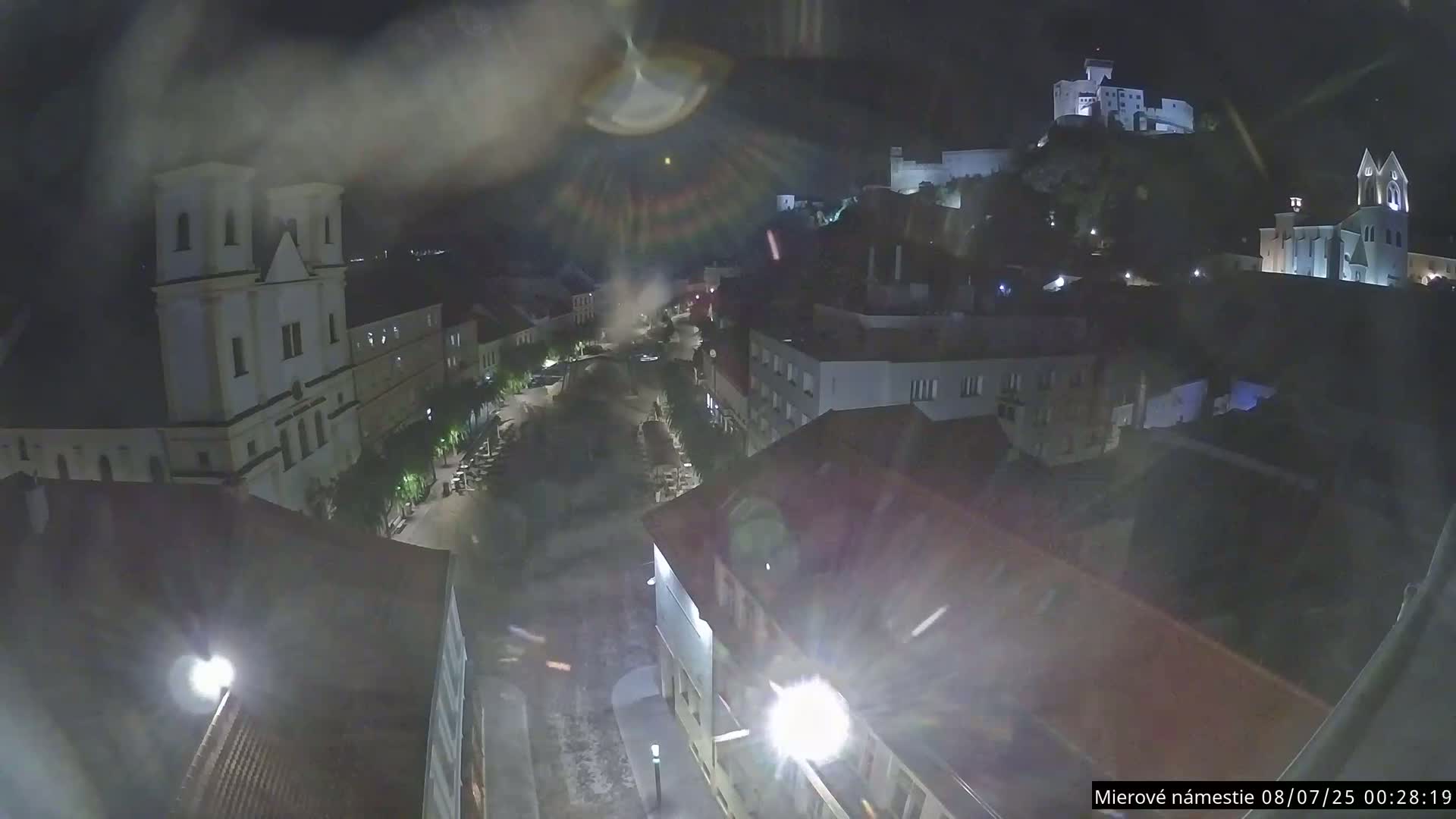 Trenčín, Piaristický kostol sv. Františka Xaverského Church & Trenciansky Hrad (Ttencin Castle) at Mierové námestie Square East View Live Cam - Trencin, Okres Trencin, Slovakia 
