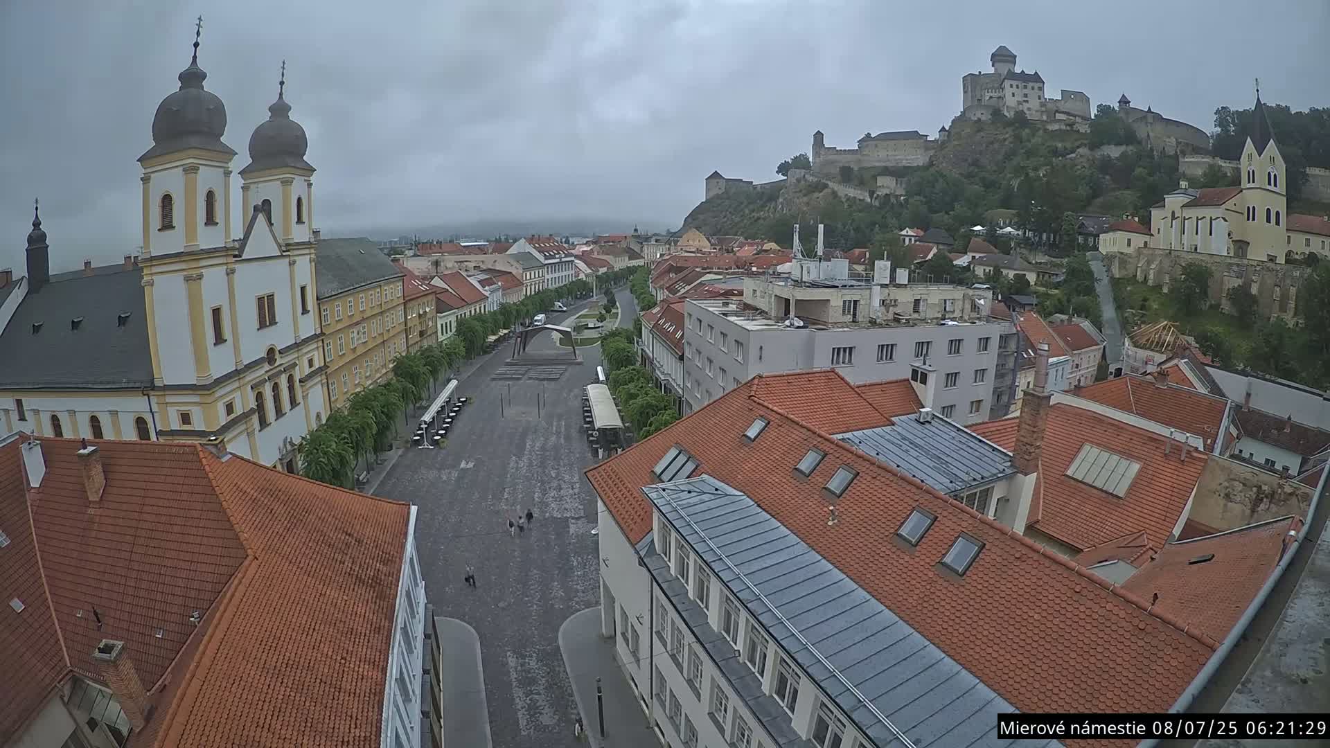 Trenčín, Piaristický kostol sv. Františka Xaverského Church & Trenciansky Hrad (Ttencin Castle) at Mierové námestie Square East View Live Cam - Trencin, Okres Trencin, Slovakia 