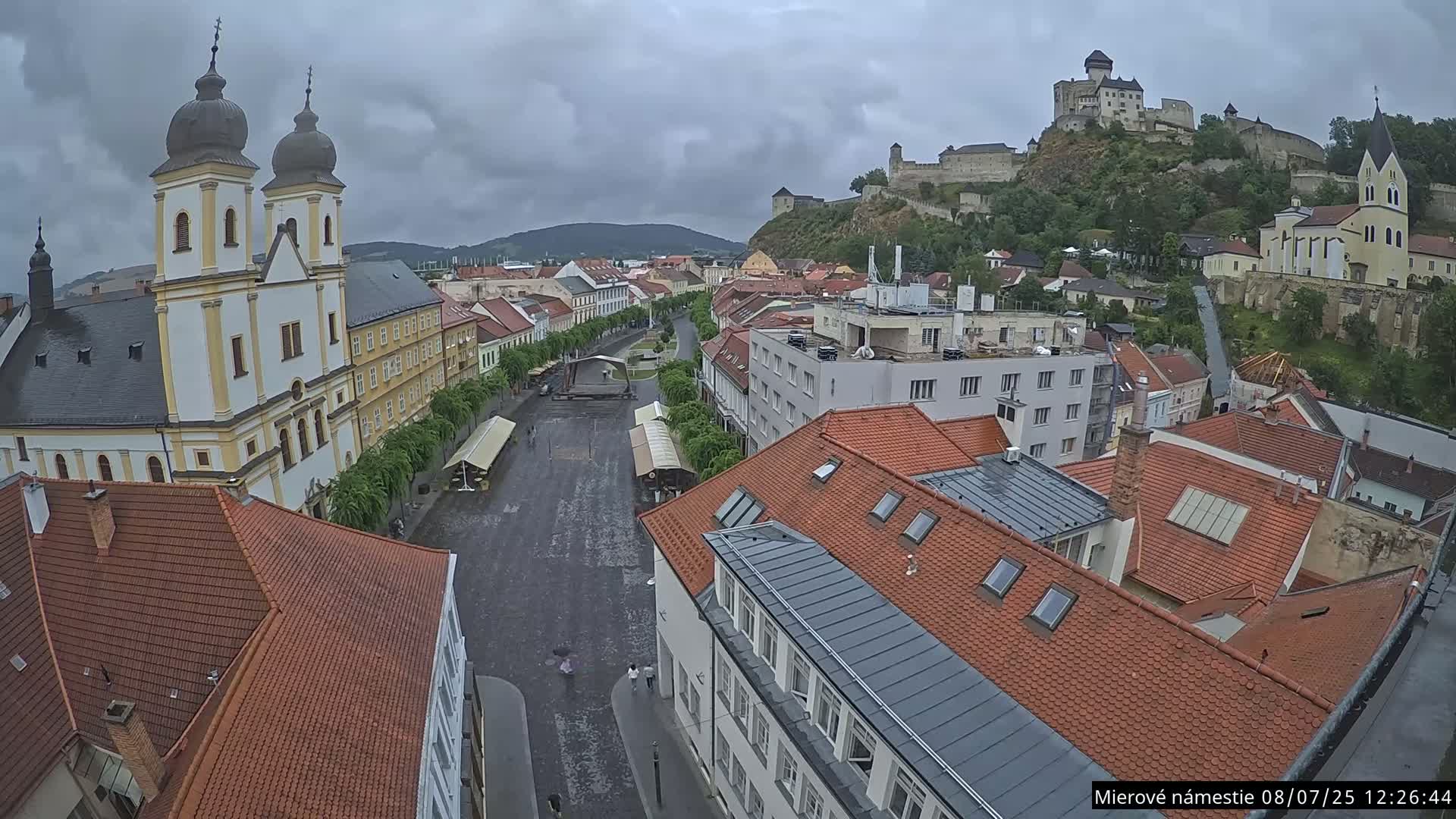 Trenčín, Piaristický kostol sv. Františka Xaverského Church & Trenciansky Hrad (Ttencin Castle) at Mierové námestie Square East View Live Cam - Trencin, Okres Trencin, Slovakia 