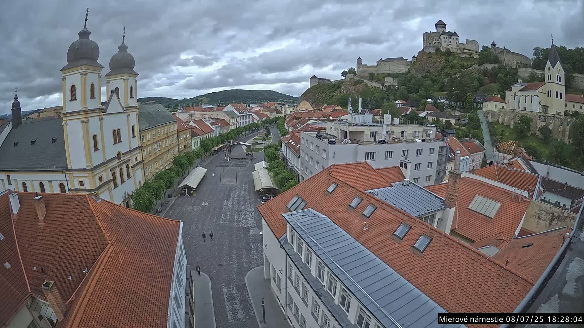 Trenčín, Piaristický kostol sv. Františka Xaverského Church & Trenciansky Hrad (Ttencin Castle) at Mierové námestie Square East View Live Cam - Trencin, Okres Trencin, Slovakia 