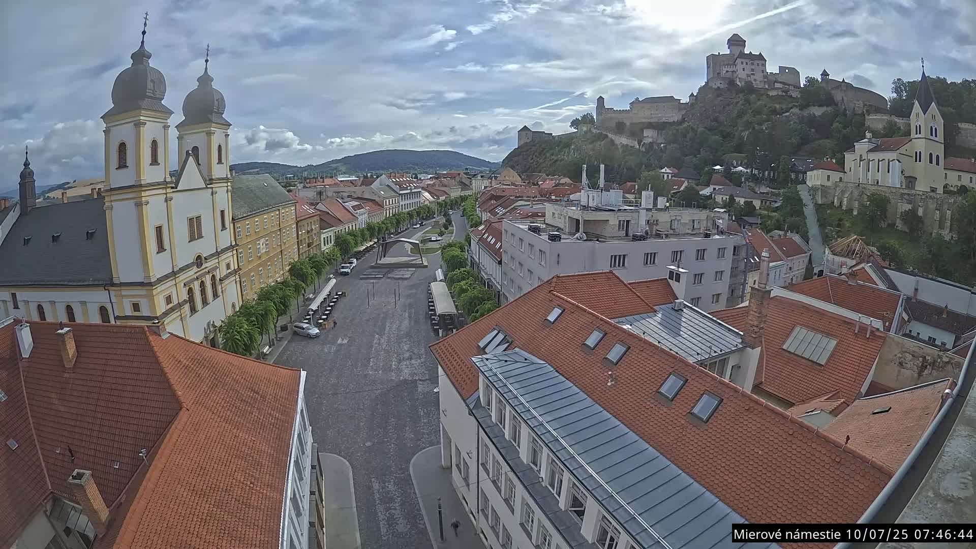 Trenčín, Piaristický kostol sv. Františka Xaverského Church & Trenciansky Hrad (Ttencin Castle) at Mierové námestie Square East View Live Cam - Trencin, Okres Trencin, Slovakia 