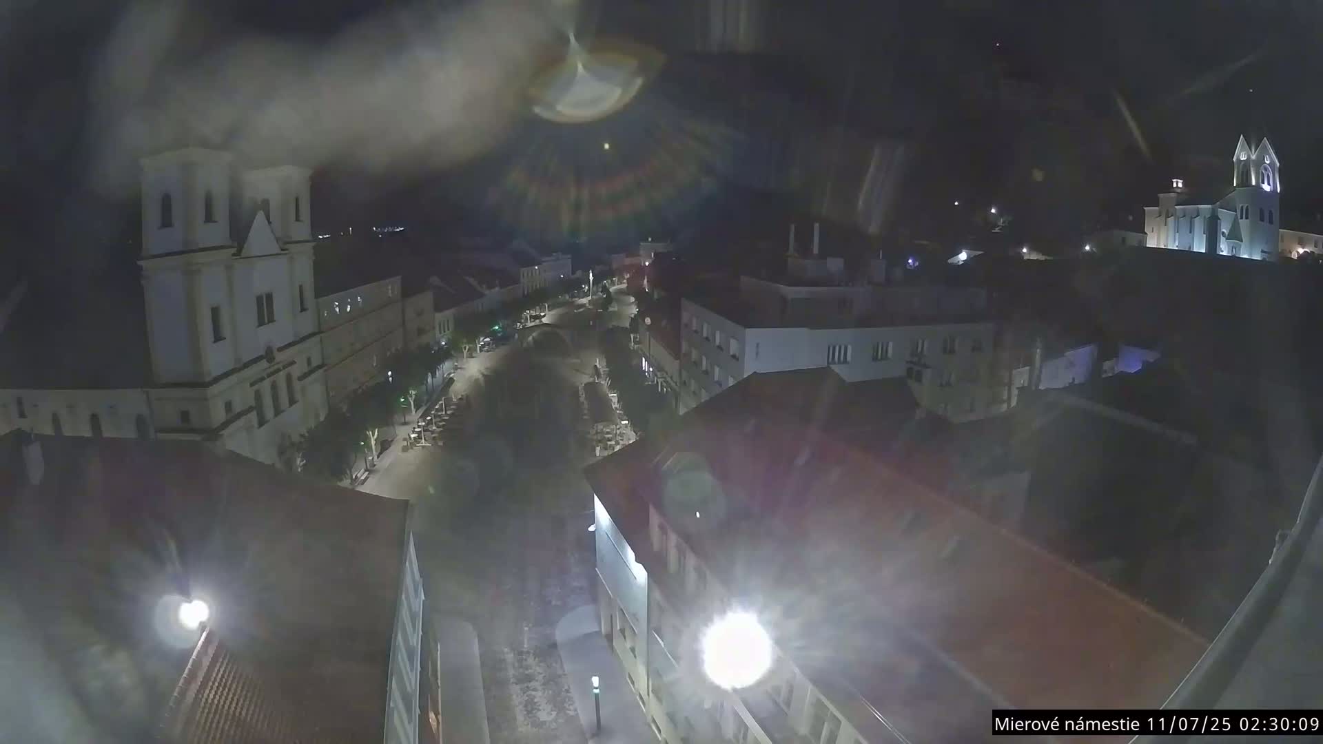 Trenčín, Piaristický kostol sv. Františka Xaverského Church & Trenciansky Hrad (Ttencin Castle) at Mierové námestie Square East View Live Cam - Trencin, Okres Trencin, Slovakia 