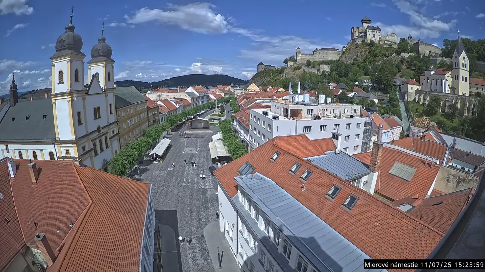 Trenčín, Piaristický kostol sv. Františka Xaverského Church & Trenciansky Hrad (Ttencin Castle) at Mierové námestie Square East View Live Cam - Trencin, Okres Trencin, Slovakia 