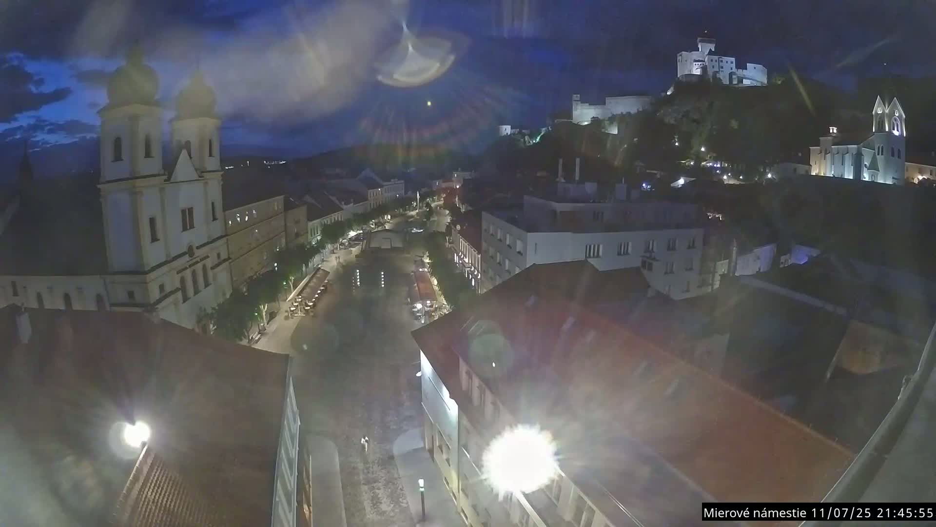 Trenčín, Piaristický kostol sv. Františka Xaverského Church & Trenciansky Hrad (Ttencin Castle) at Mierové námestie Square East View Live Cam - Trencin, Okres Trencin, Slovakia 