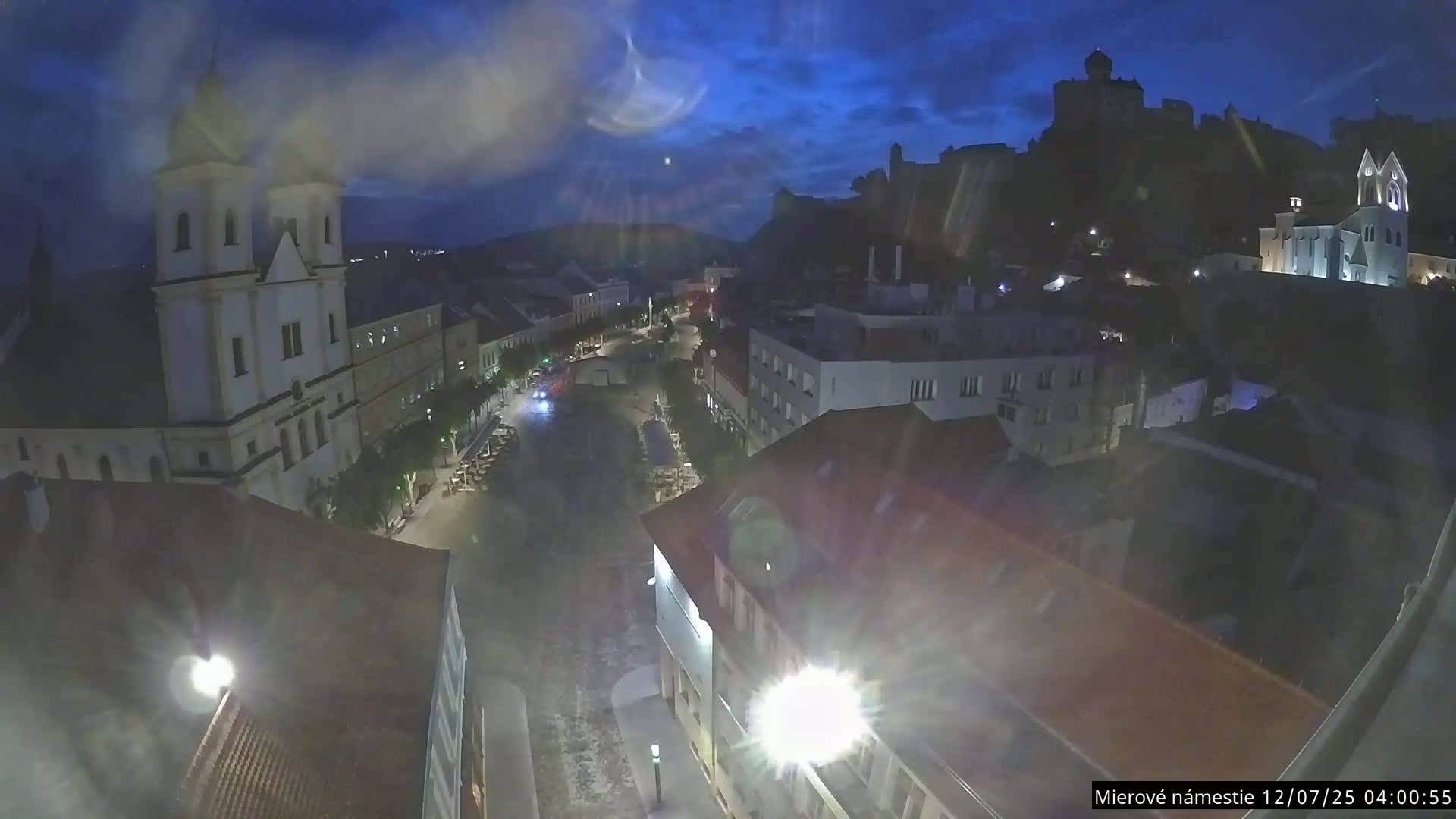 Trenčín, Piaristický kostol sv. Františka Xaverského Church & Trenciansky Hrad (Ttencin Castle) at Mierové námestie Square East View Live Cam - Trencin, Okres Trencin, Slovakia 