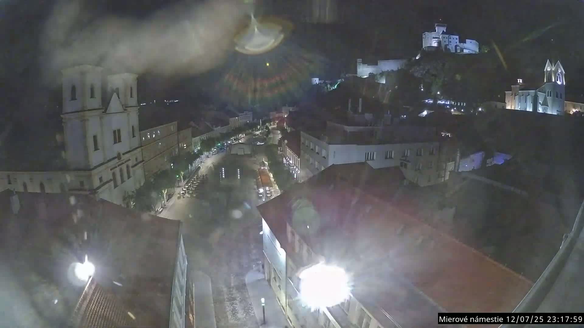 Trenčín, Piaristický kostol sv. Františka Xaverského Church & Trenciansky Hrad (Ttencin Castle) at Mierové námestie Square East View Live Cam - Trencin, Okres Trencin, Slovakia 