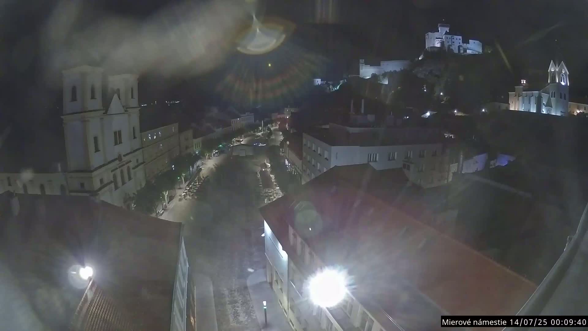 Trenčín, Piaristický kostol sv. Františka Xaverského Church & Trenciansky Hrad (Ttencin Castle) at Mierové námestie Square East View Live Cam - Trencin, Okres Trencin, Slovakia 