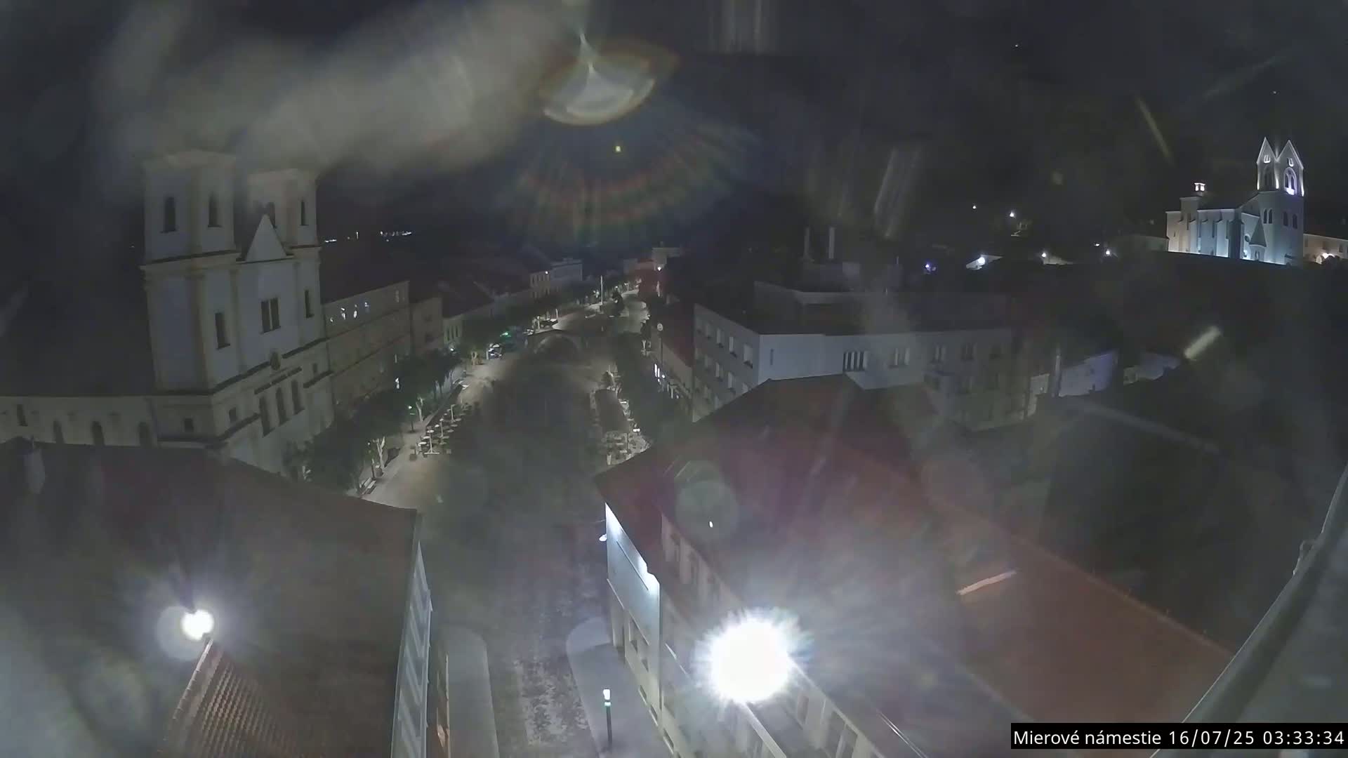 Trenčín, Piaristický kostol sv. Františka Xaverského Church & Trenciansky Hrad (Ttencin Castle) at Mierové námestie Square East View Live Cam - Trencin, Okres Trencin, Slovakia 