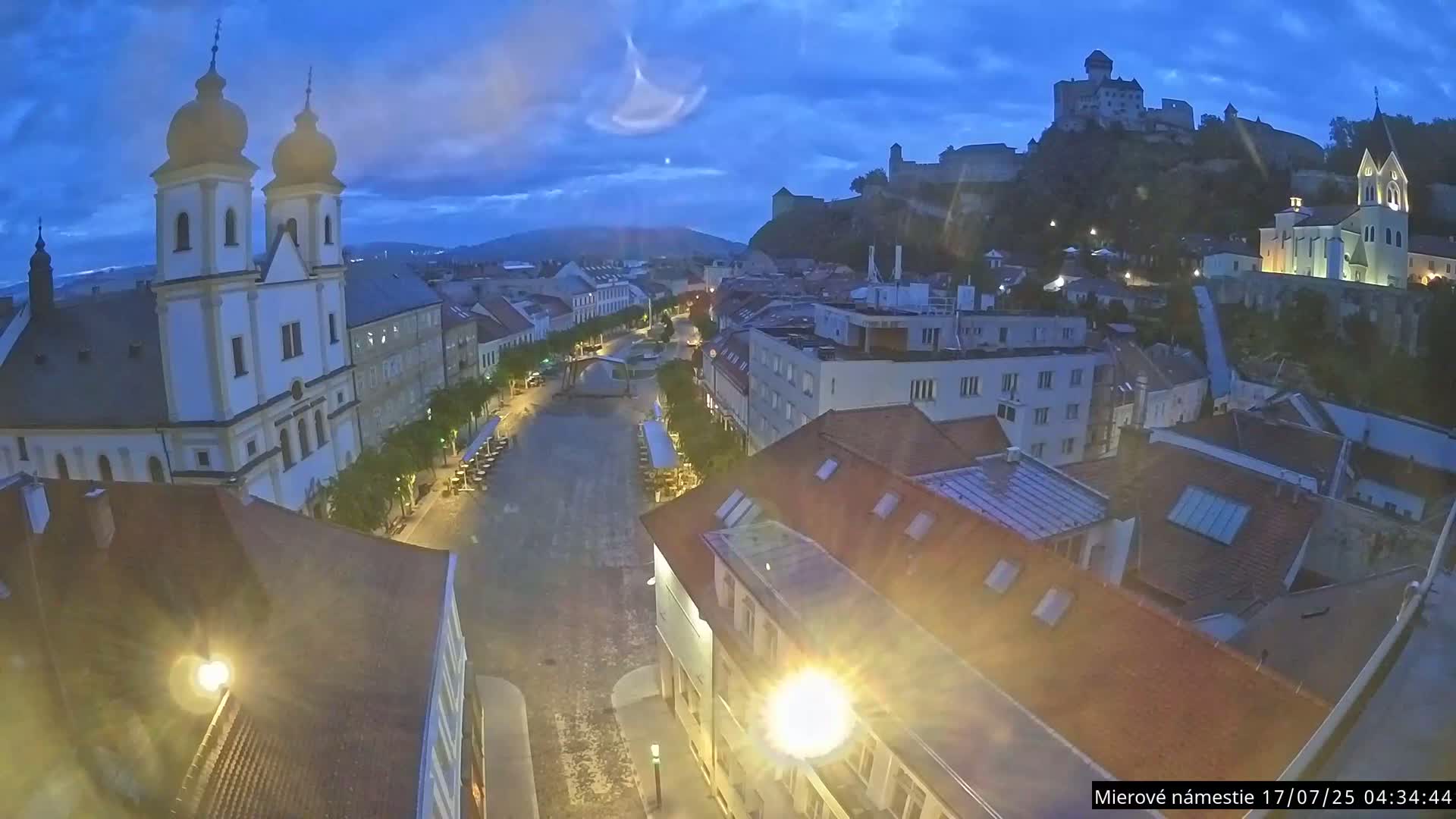 Trenčín, Piaristický kostol sv. Františka Xaverského Church & Trenciansky Hrad (Ttencin Castle) at Mierové námestie Square East View Live Cam - Trencin, Okres Trencin, Slovakia 