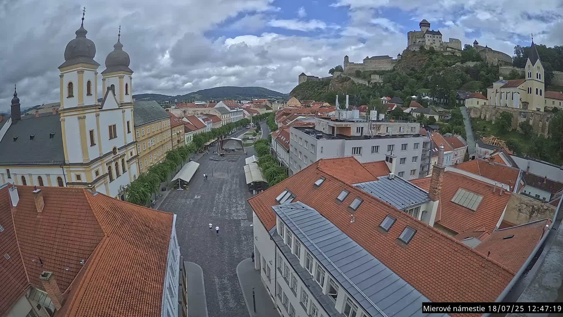 Trenčín, Piaristický kostol sv. Františka Xaverského Church & Trenciansky Hrad (Ttencin Castle) at Mierové námestie Square East View Live Cam - Trencin, Okres Trencin, Slovakia 