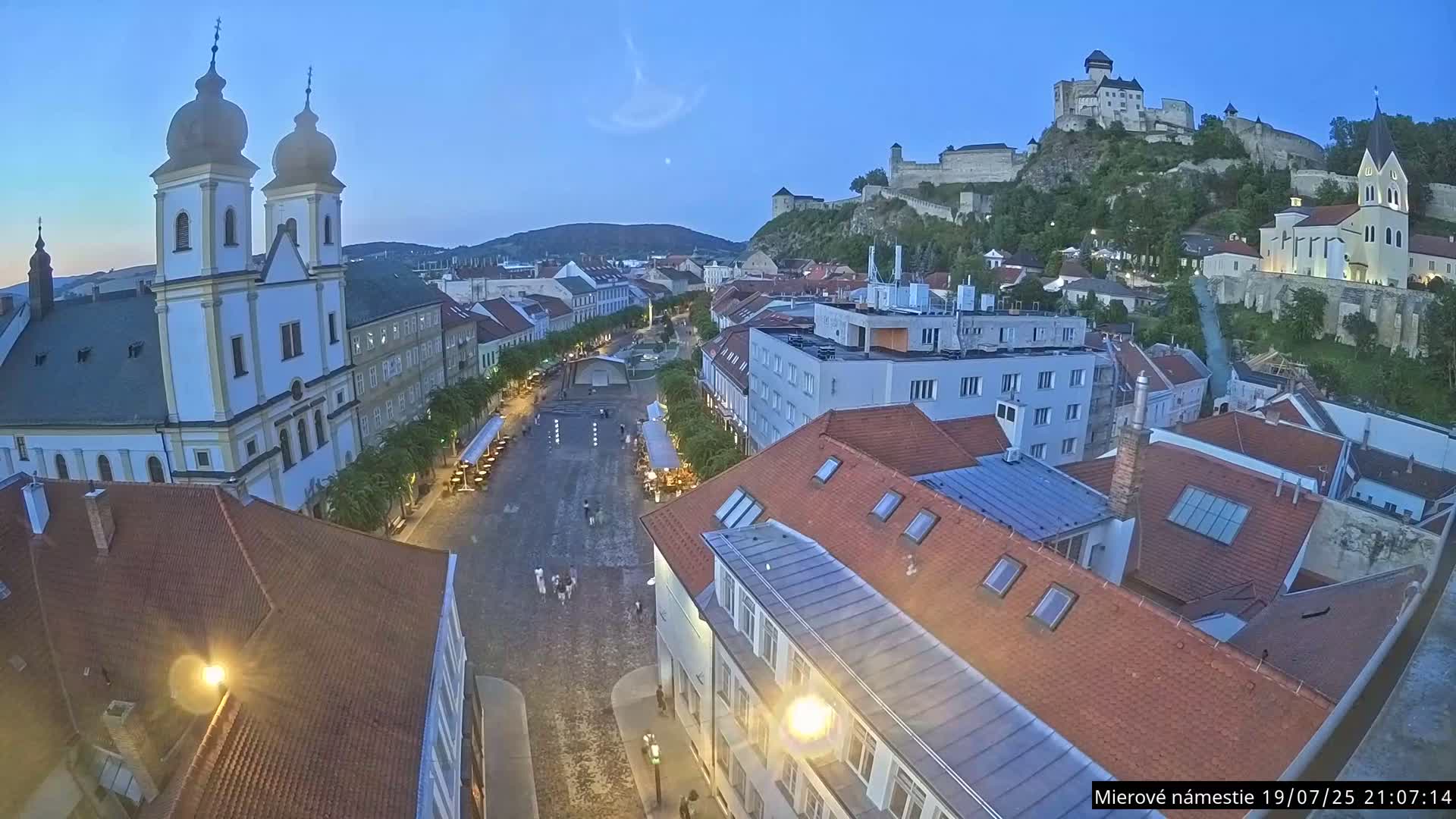 Trenčín, Piaristický kostol sv. Františka Xaverského Church & Trenciansky Hrad (Ttencin Castle) at Mierové námestie Square East View Live Cam - Trencin, Okres Trencin, Slovakia 