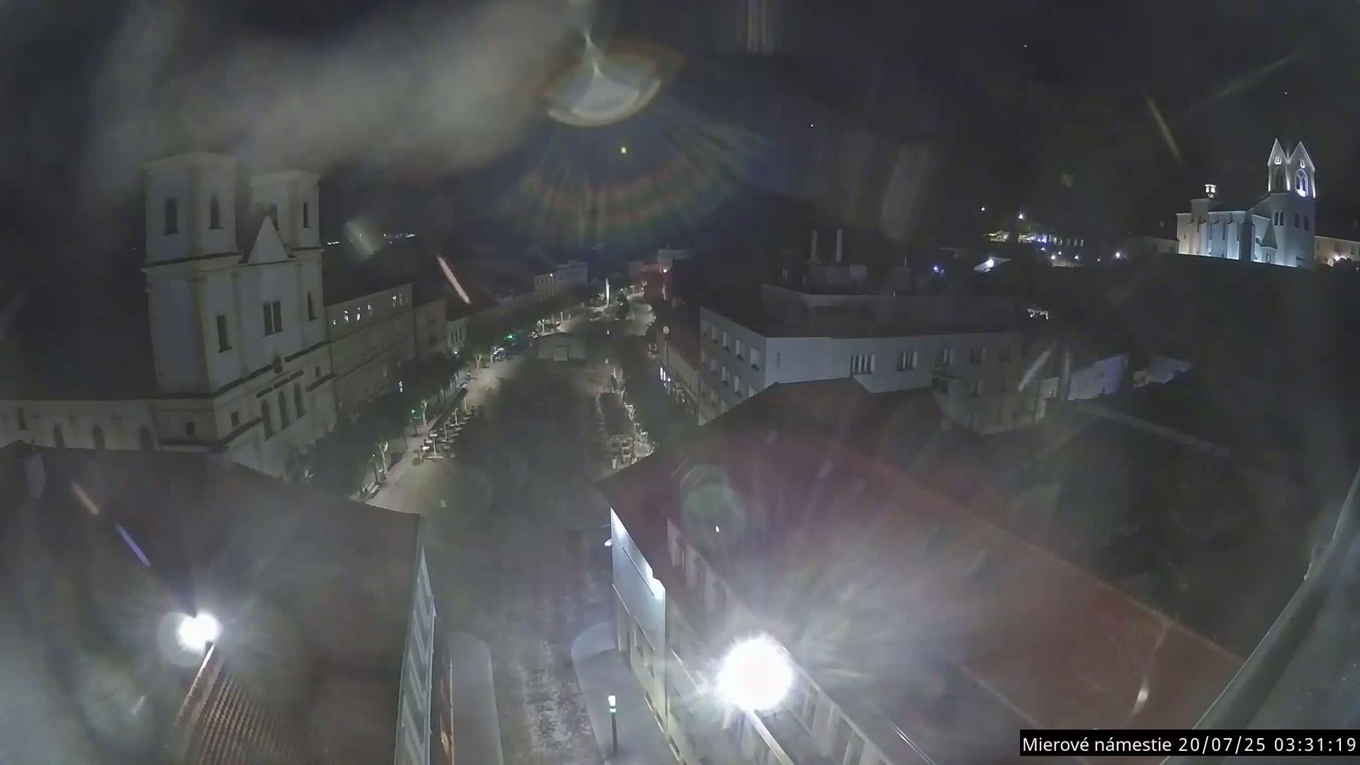 Trenčín, Piaristický kostol sv. Františka Xaverského Church & Trenciansky Hrad (Ttencin Castle) at Mierové námestie Square East View Live Cam - Trencin, Okres Trencin, Slovakia 