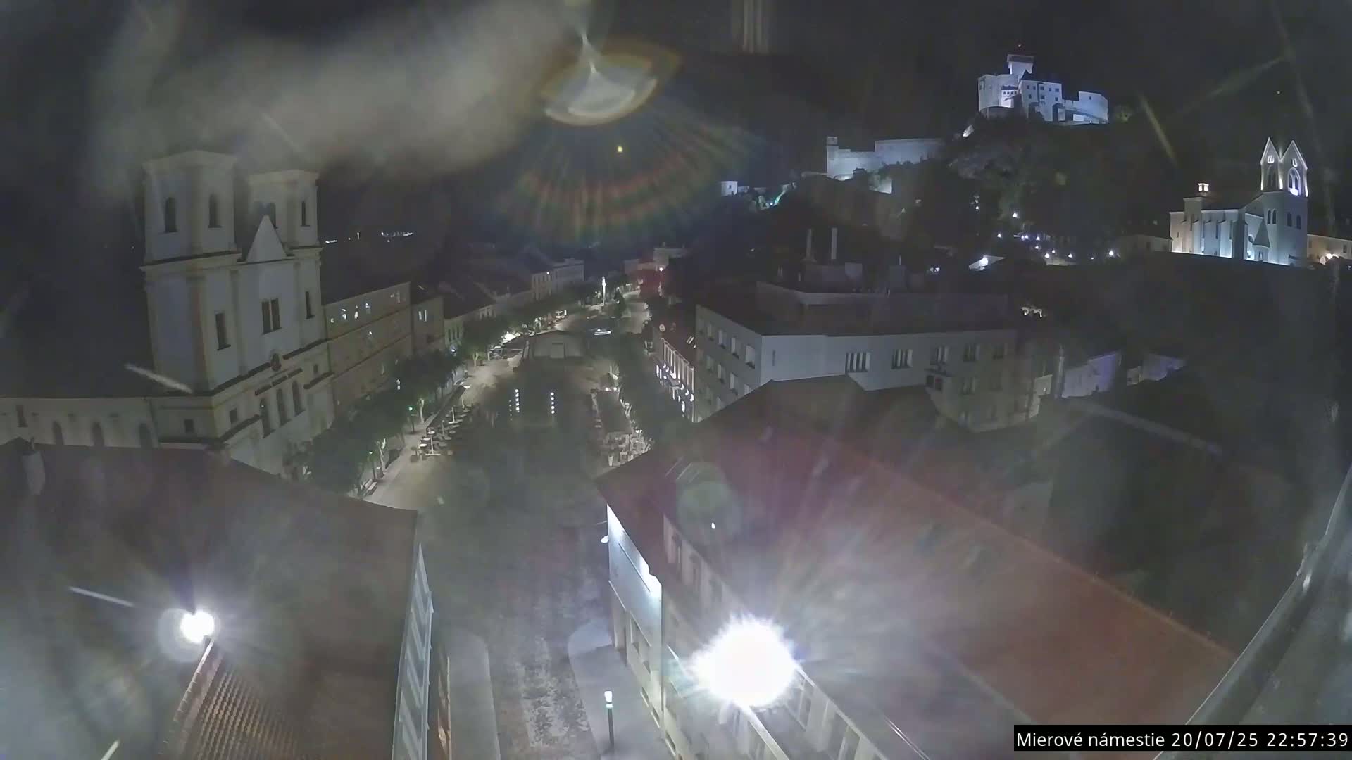 Trenčín, Piaristický kostol sv. Františka Xaverského Church & Trenciansky Hrad (Ttencin Castle) at Mierové námestie Square East View Live Cam - Trencin, Okres Trencin, Slovakia 