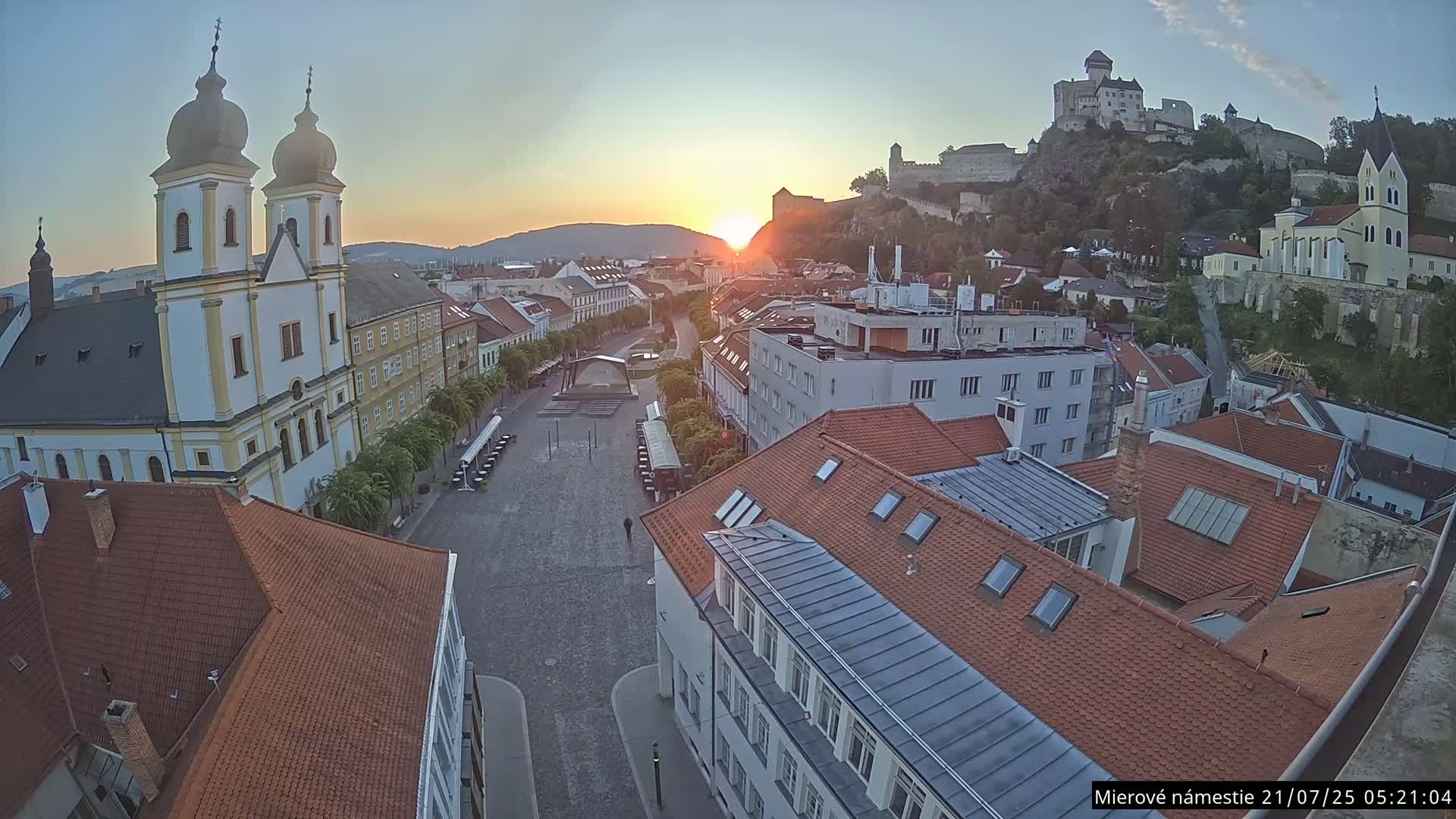 Trenčín, Piaristický kostol sv. Františka Xaverského Church & Trenciansky Hrad (Ttencin Castle) at Mierové námestie Square East View Live Cam - Trencin, Okres Trencin, Slovakia 