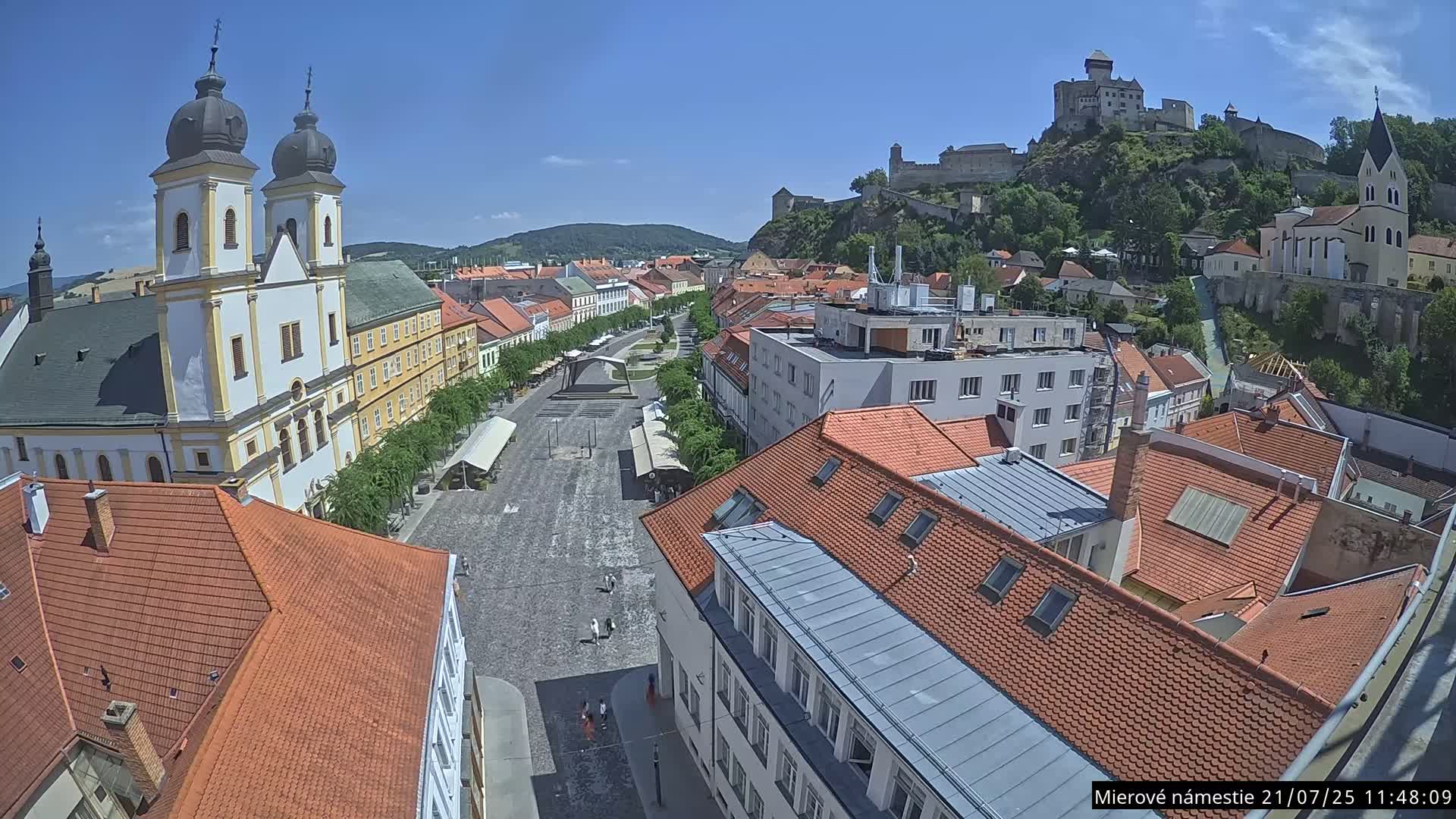 Trenčín, Piaristický kostol sv. Františka Xaverského Church & Trenciansky Hrad (Ttencin Castle) at Mierové námestie Square East View Live Cam - Trencin, Okres Trencin, Slovakia 